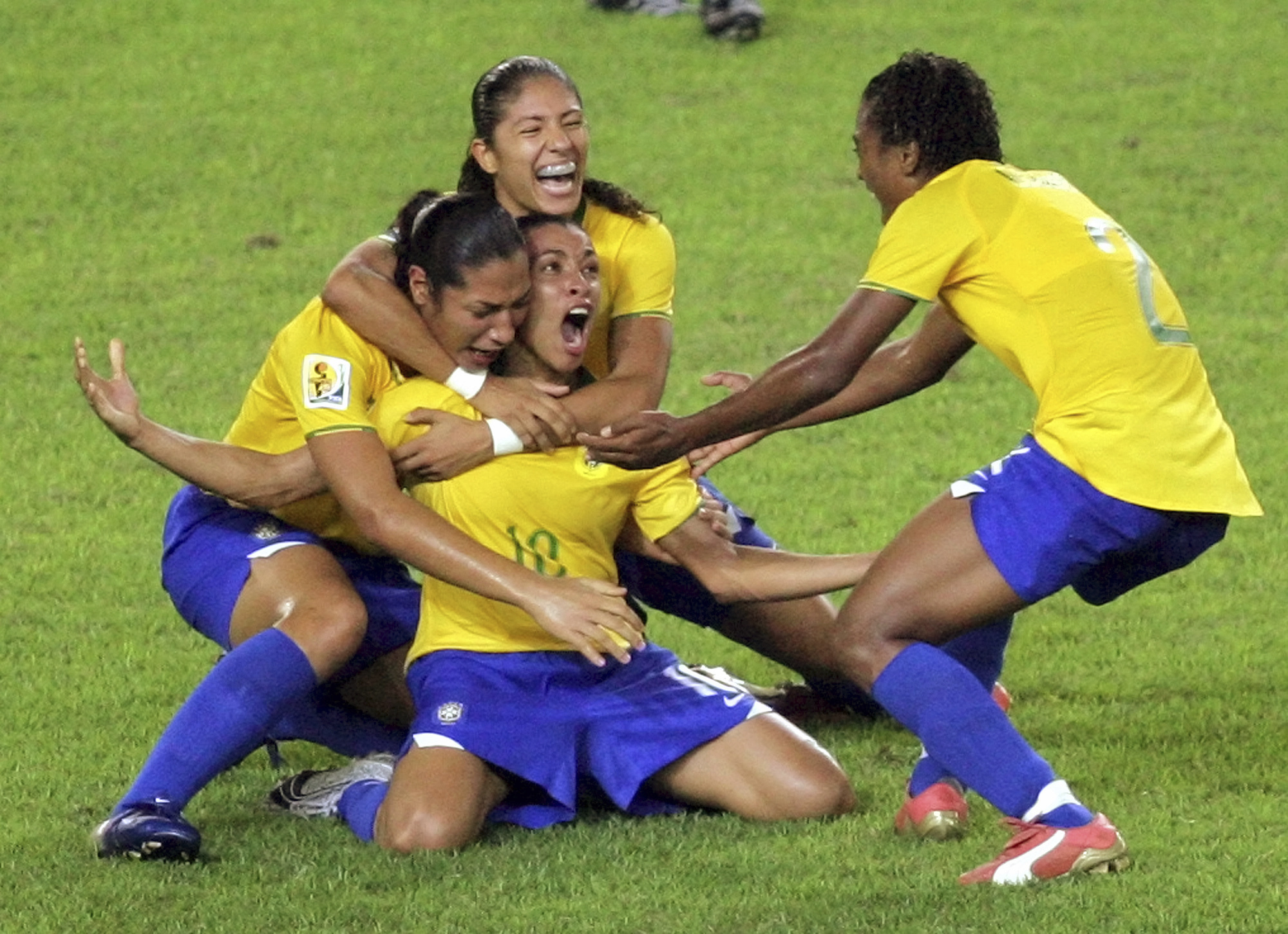 FILE - Brazil's Marta, center, celebrates her goal against the United States during a FIFA Women's World Cup semifinal soccer match in Hangzhou, China, Sept. 27, 2007. The six-time women's world player of the year plans to retire from the national team after 2024. (AP Photo/Greg Baker, File)