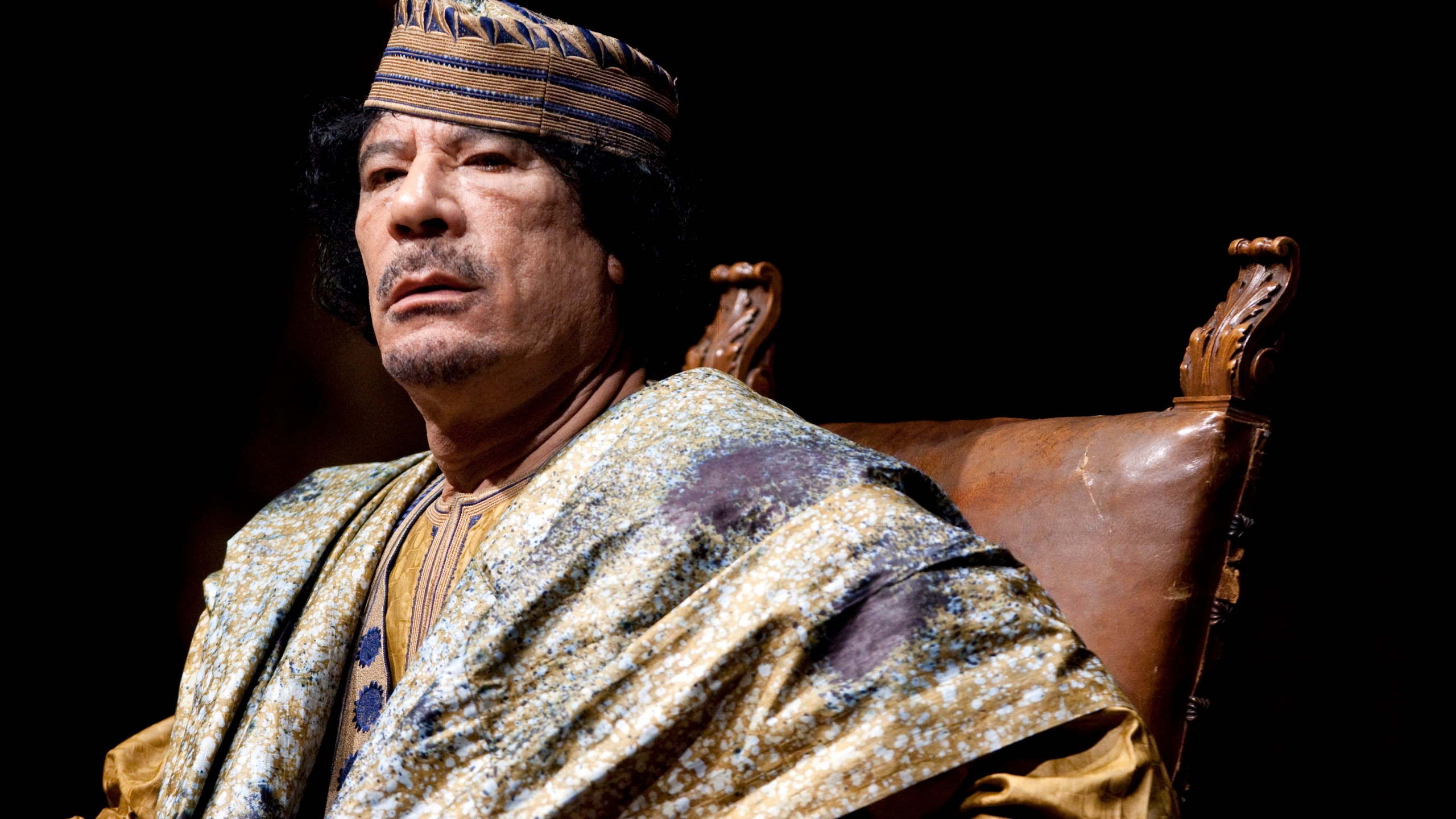 FILE - Libyan leader Muammar Gadhafi delivers his speech during a meeting with hundreds of prominent Italian women in a concert hall, June 12, 2009, in Rome. The former Libyan leader was captured and killed by rebels shortly after the International Criminal Court issued a warrant for his arrest on charges linked to the brutal suppression of anti-government protests in 2011. (AP Photo/Andrew Medichini, File)