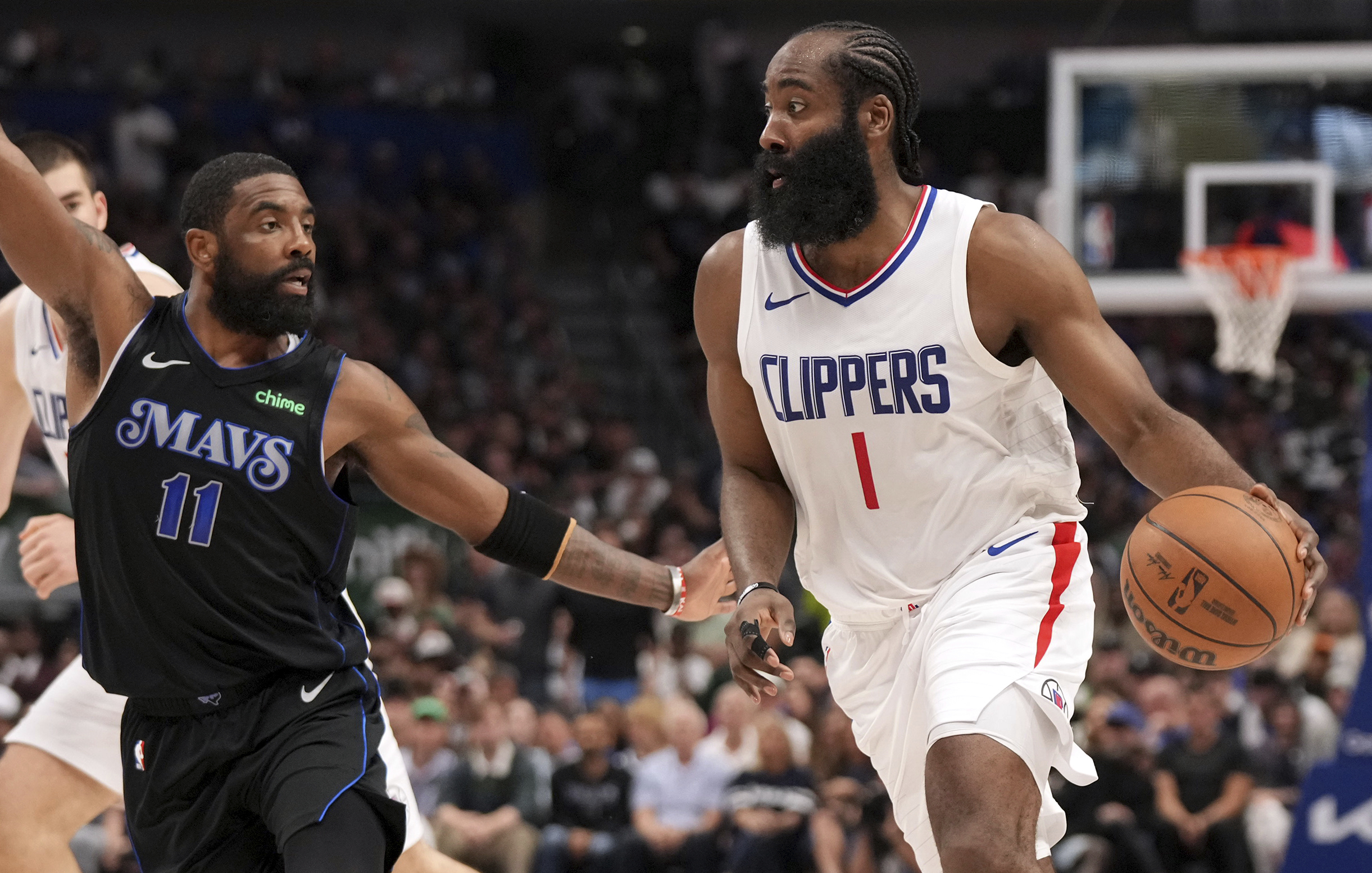 Los Angeles Clippers guard James Harden (1) drives against Dallas Mavericks guard Kyrie Irving (11) during the first half of Game 6 of an NBA basketball first-round playoff series Friday, May 3, 2024, in Dallas. (AP Photo/Jeffrey McWhorter)