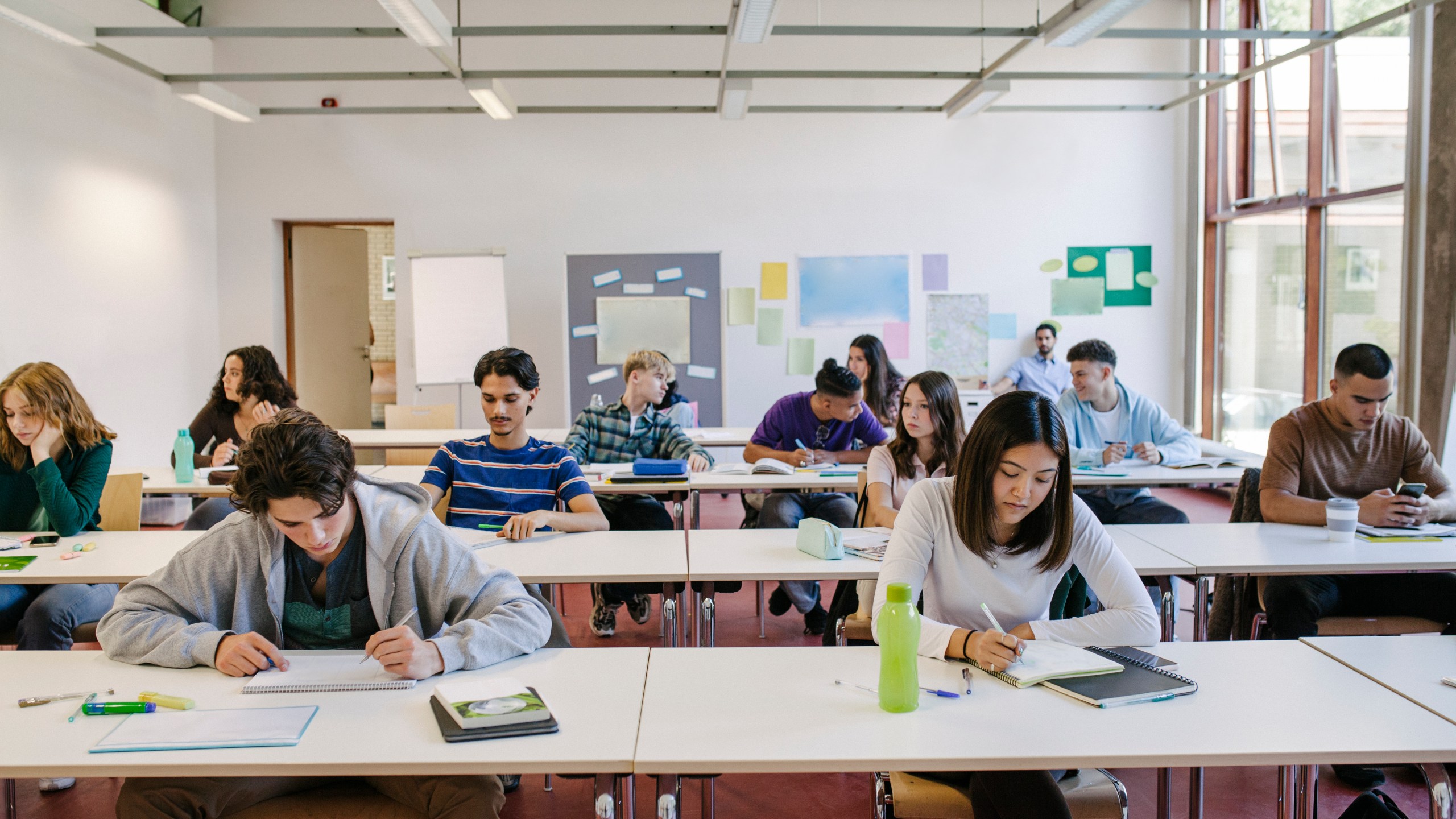 A group of high school students at their desks working hard during a class. (Getty Images)