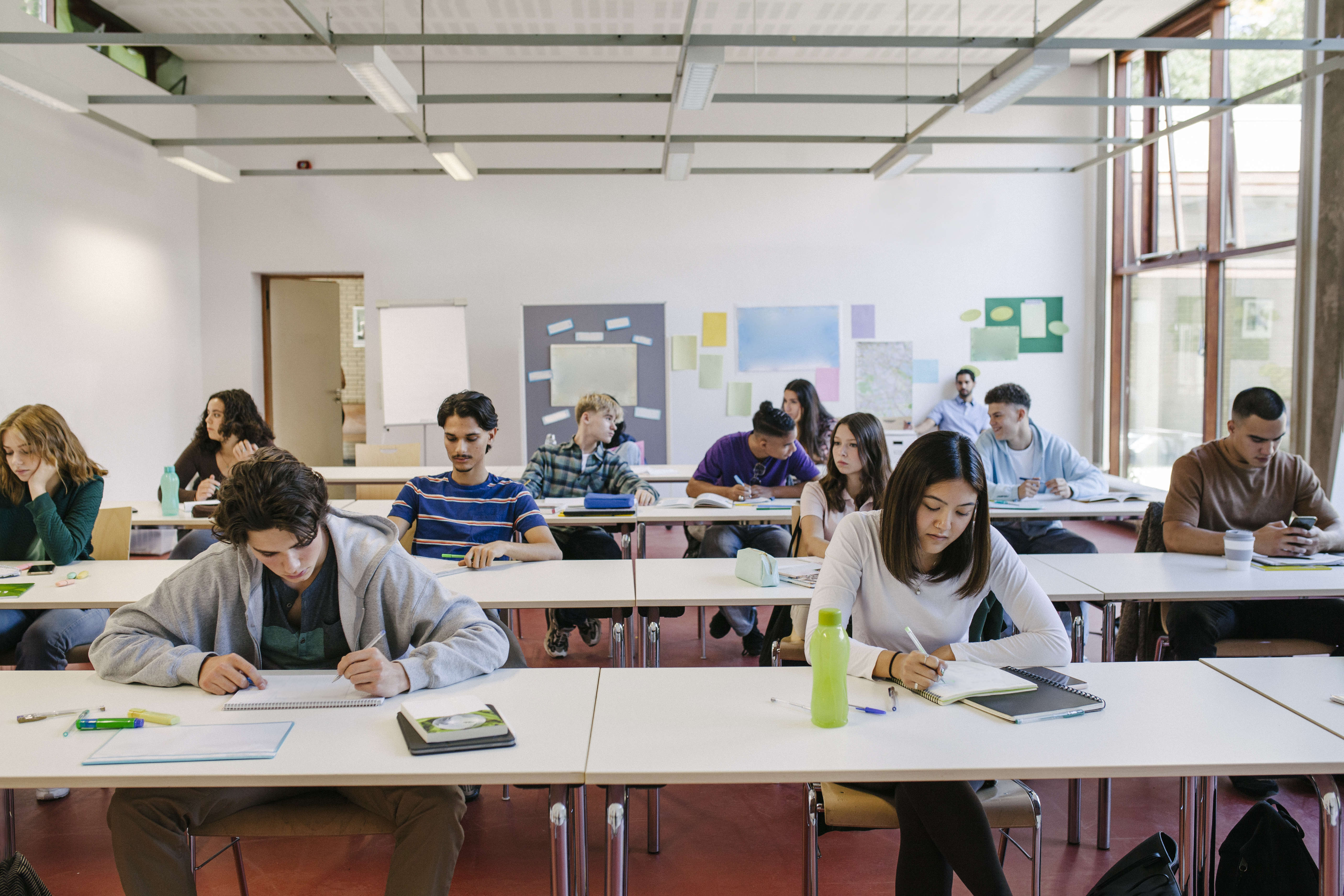 A group of high school students at their desks working hard during a class. (Getty Images)