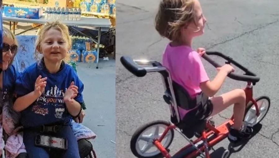 Alli Booth, 7, is seen riding her custom adaptive tricycle. (GoFundMe)