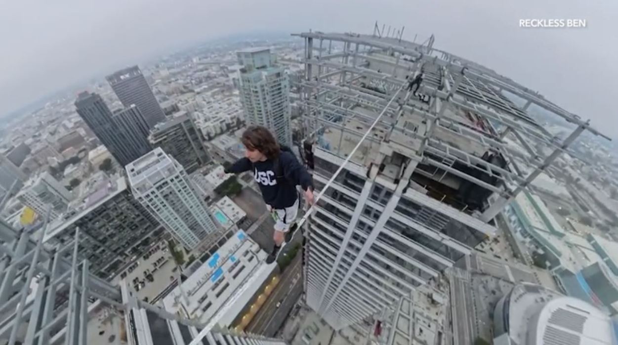 YouTube daredevil and performance artist Ben Schneider is seen walking a small rope tied between two skyscrapers in downtown Los Angeles on May 12, 2024. (Ben Schneider)