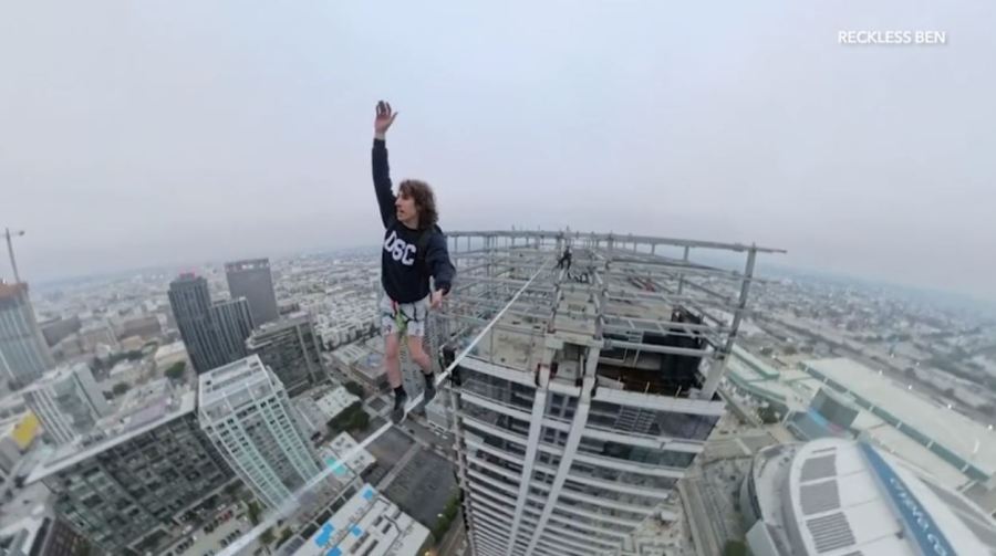 YouTube daredevil and performance artist Ben Schneider is seen walking a small rope tied between two skyscrapers in downtown Los Angeles on May 12, 2024. (Ben Schneider)