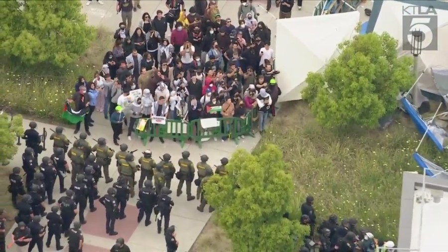 Law enforcement officers are seen approaching a protest encampment at UC Irvine on May 15, 2024. (KTLA)