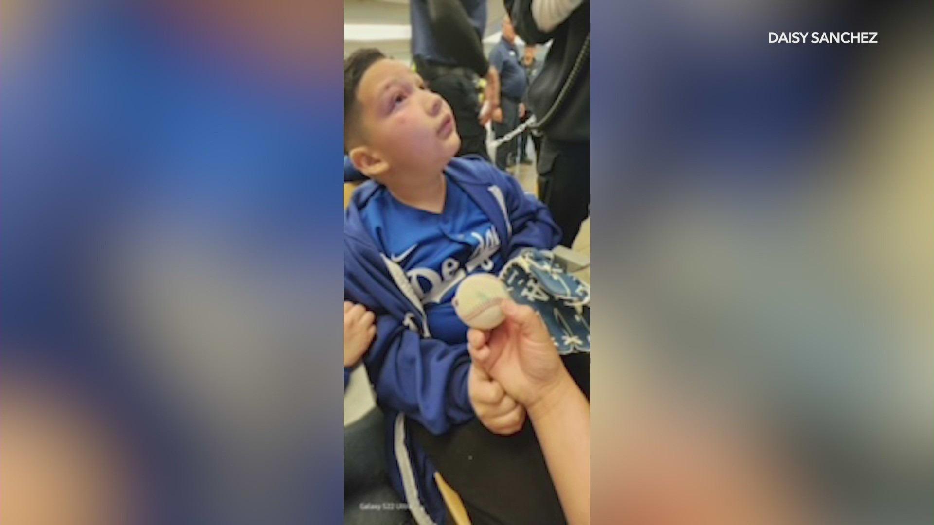 Eight-year-old Nathan Sanchez being tended to by medical officials after being hit in the face by a foul ball at Dodgers Stadium on May 17, 2024. (Sanchez Family)