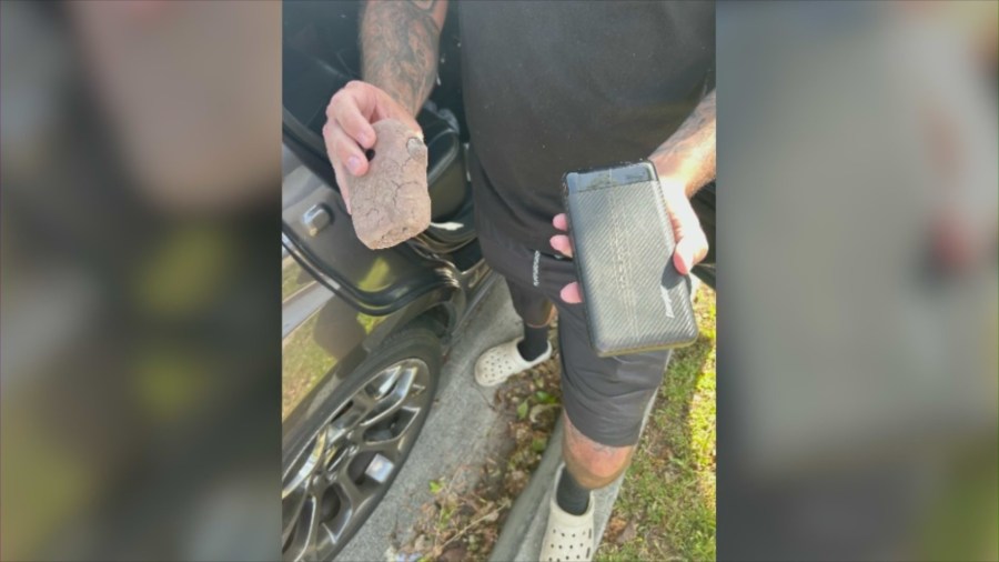 A hidden camera disguised as a rock, along with a power bank underneath, was discovered in a Chino Hills neighborhood. (KTLA)