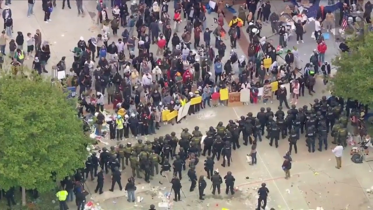 Law enforcement officers are seen approaching a protest encampment at UC Irvine on May 15, 2024. (KTLA)