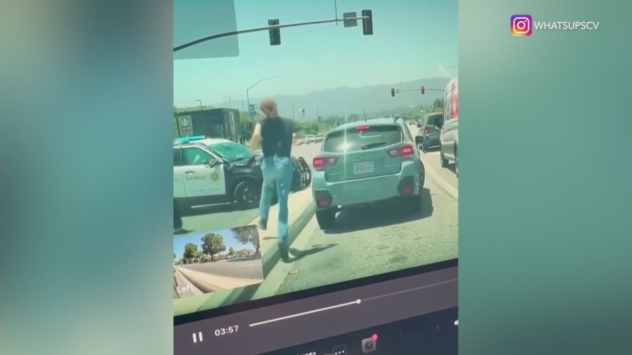 Bystanders running to help the L.A. County sheriff's deputy after a violent rollover crash in Santa Clarita on May 29, 2024. (@whatsupscv)