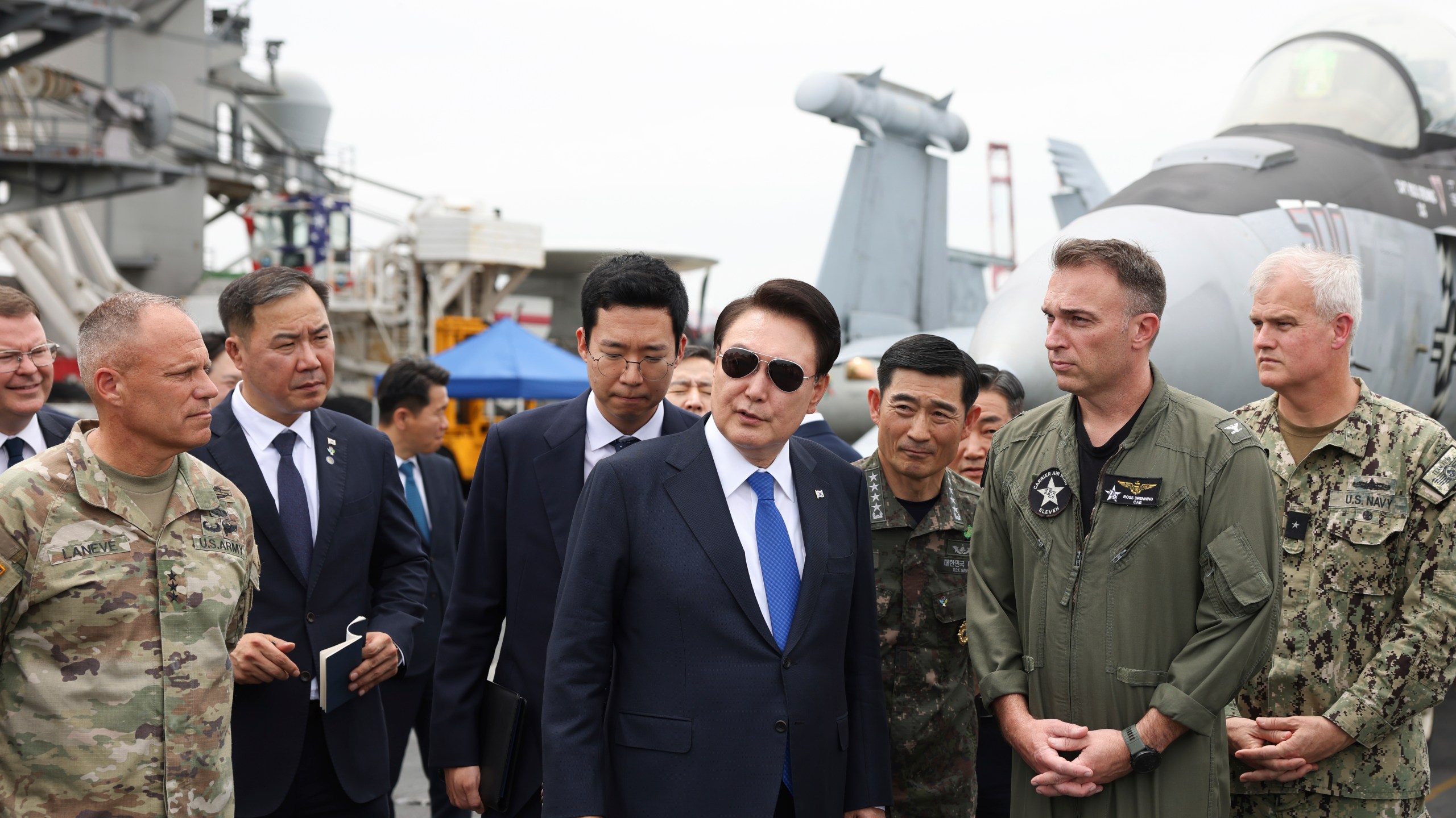 South Korean President Yoon Suk Yeol, center, boards the USS Theodore Roosevelt aircraft carrier at the South Korean naval base in Busan, South Korea, Tuesday, June 25, 2024 (South Korean Presidential Office/Yonhap via AP)