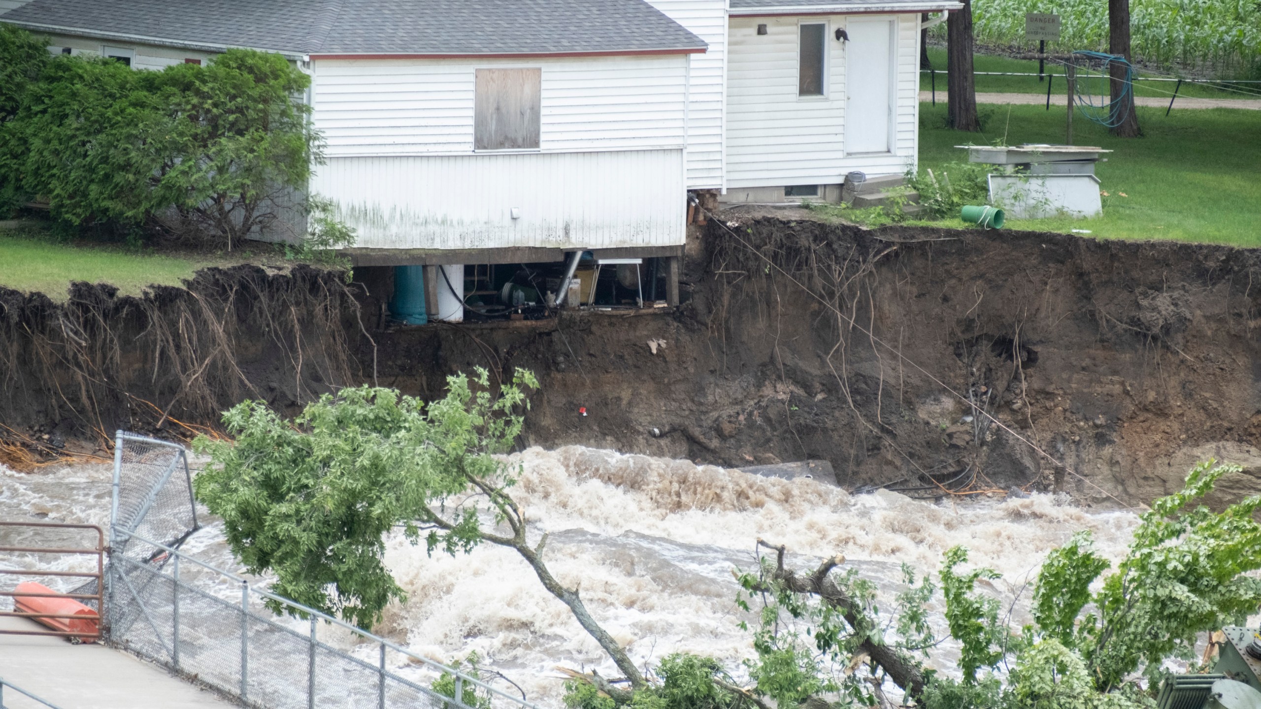 The innards of a house near the Rapidan Dam in Rapidan, Minn., are visible as waters from the Blue Earth River rush by, Monday, June 24, 2024. (Casey Ek/The Free Press via AP)