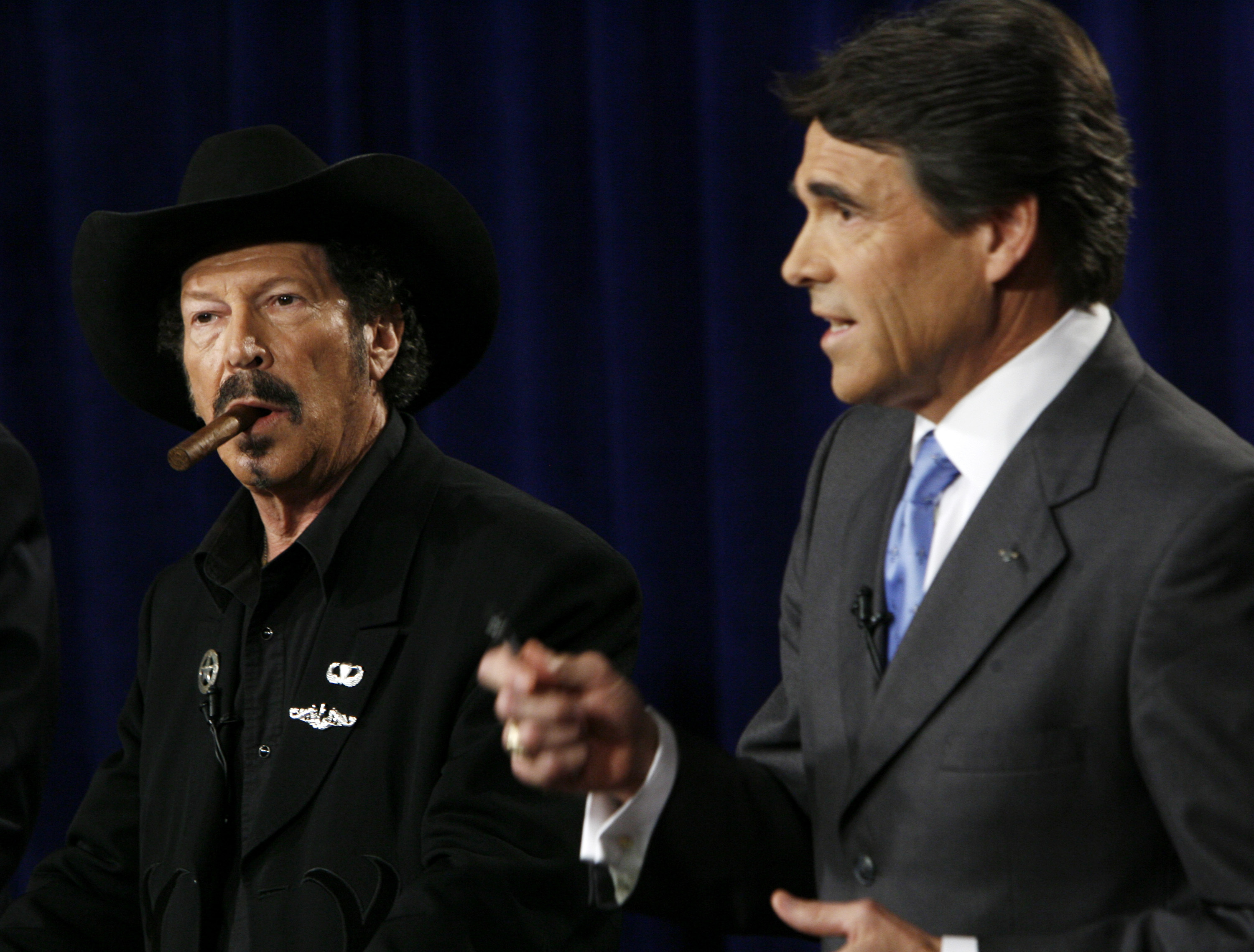 FILE - Texas gubernatorial candidate Kinky Friedman, left, listens as Gov. Rick Perry makes a comment during an on-air debate in Dallas on Oct. 6, 2006. Friedman, the singer, songwriter, satirist and novelist who also dabbled in Texas politics with a campaign for governor, died Thursday at his family’s Texas ranch near San Antonio. He was 79. (AP Photo/Smiley N. Pool, File)