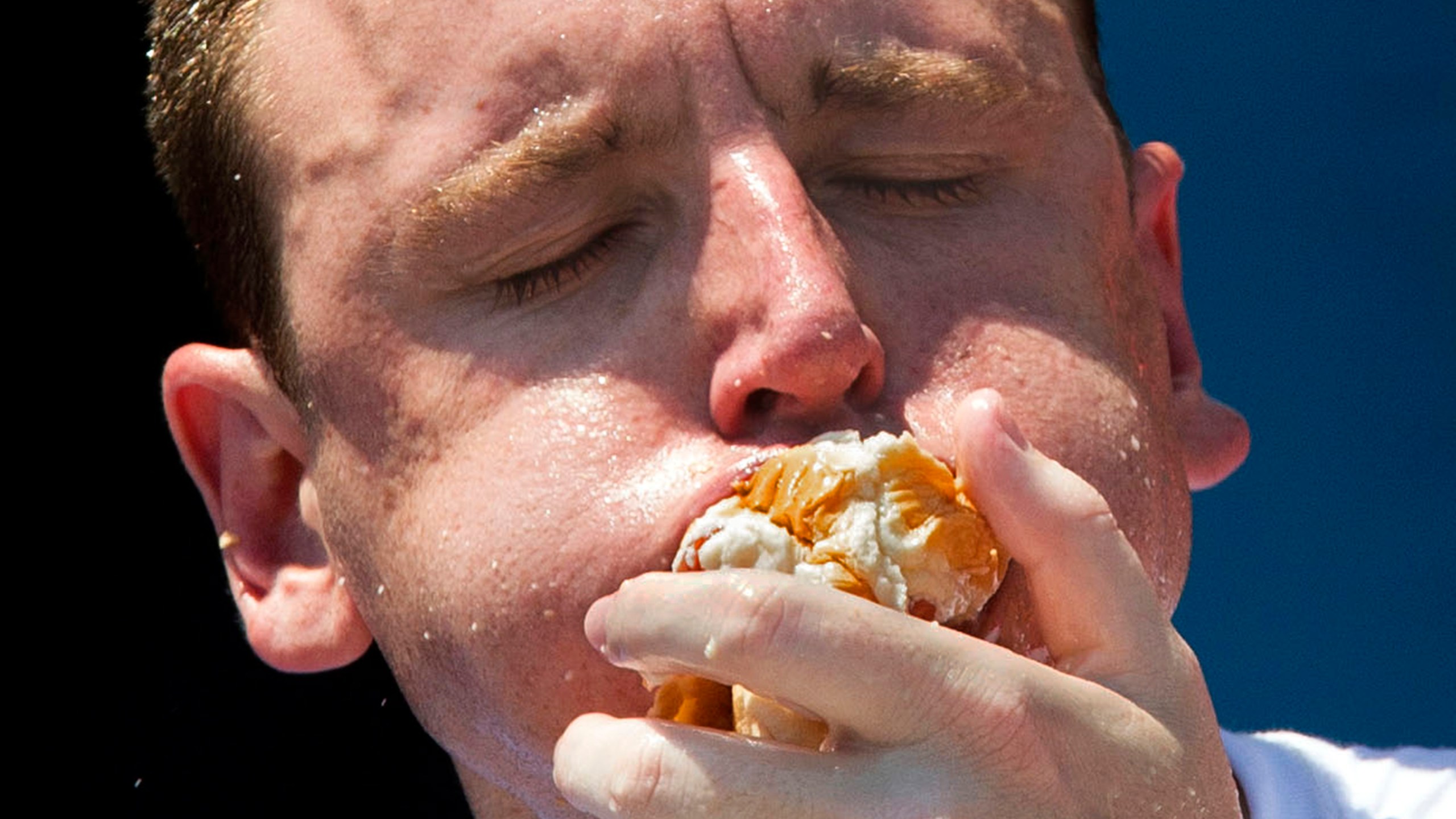 FILE - Five-time reigning champion Joey Chestnut competes in the Nathan's Famous Hot Dog Eating World Championship, July 4, 2012, at Coney Island, in the Brooklyn borough of New York. Chestnut will take his hot dog-downing talents to an army base in Texas for America's Independence Day this year, after a falling out with organizers of the annual New York City-based event. (AP Photo/John Minchillo, File)
