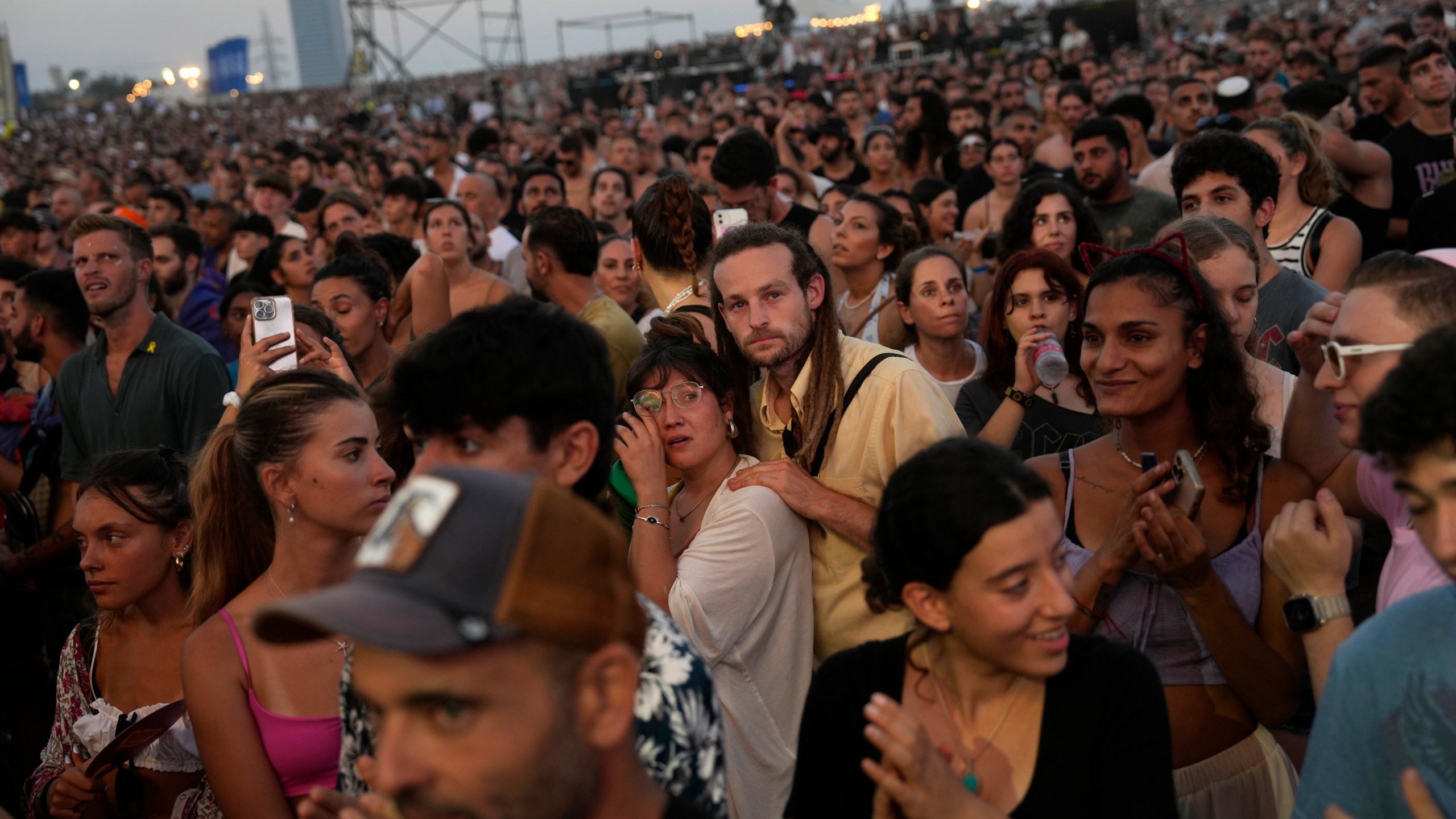 A woman weeps as her companion comforts her at the Nova Healing Concert in Tel Aviv, Israel, on Thursday, June 27, 2024. This was the first Tribe of Nova mass gathering since the Oct. 7, 2023 cross-border attack by Hamas that left hundreds at the Nova music festival dead or kidnapped to Gaza. (AP Photo/Ohad Zwigenberg)