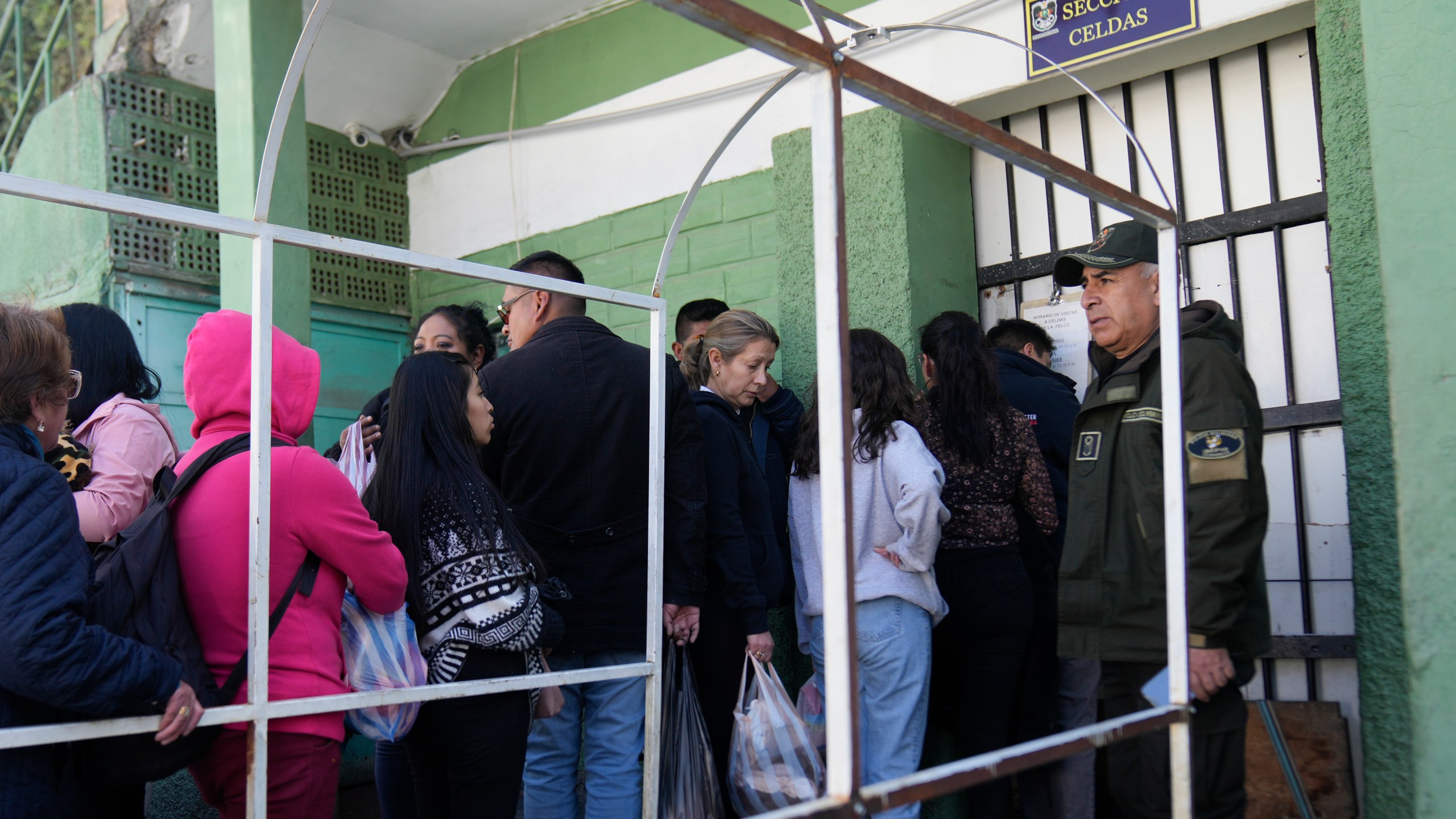 People line up outside a jail to leave food for their relatives who were detained in connection with alleged involvement in what President Luis Arce called a coup attempt in La Paz, Bolivia, Friday, June 28, 2024. (AP Photo/Juan Karita)