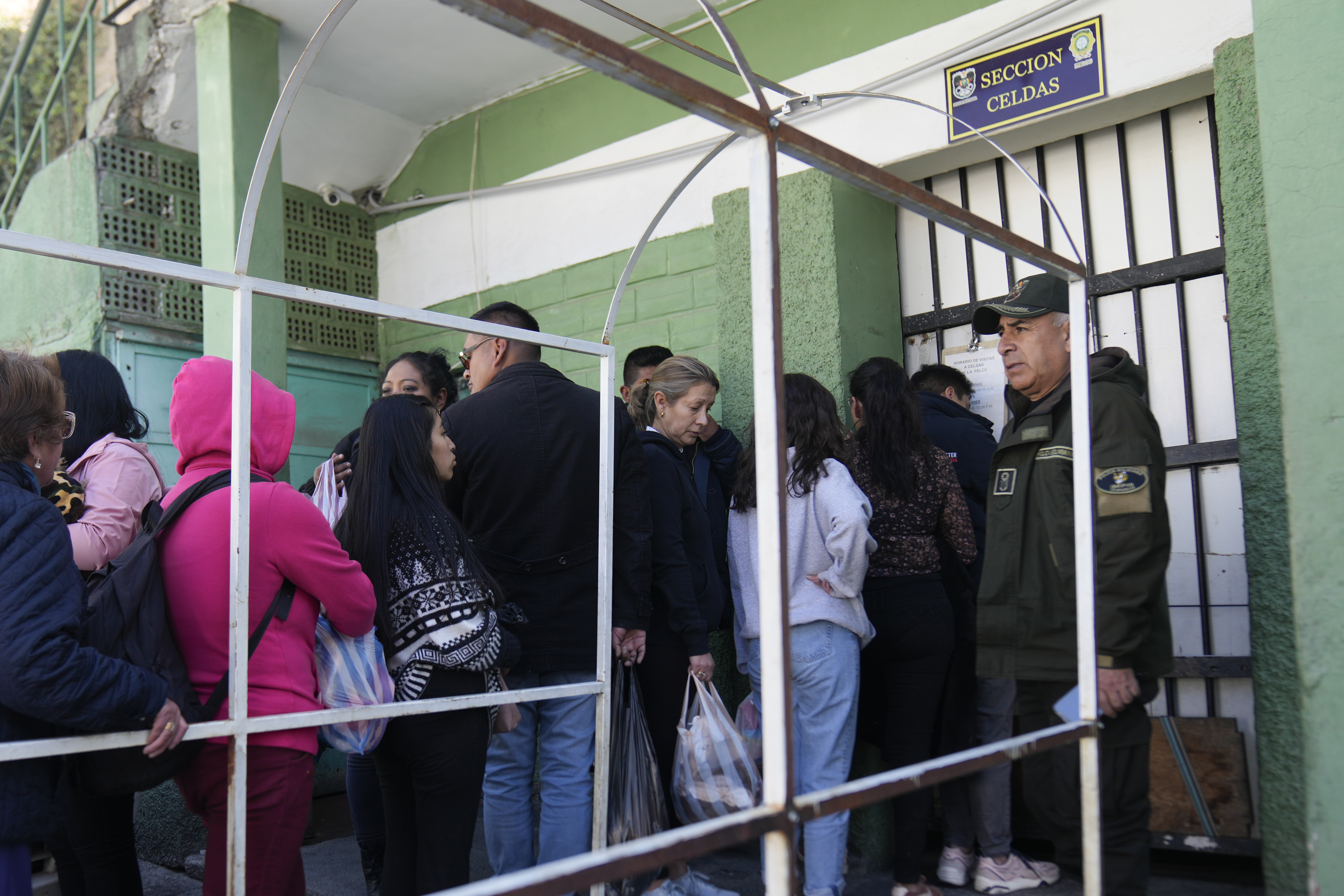 People line up outside a jail to leave food for their relatives who were detained in connection with alleged involvement in what President Luis Arce called a coup attempt in La Paz, Bolivia, Friday, June 28, 2024. (AP Photo/Juan Karita)