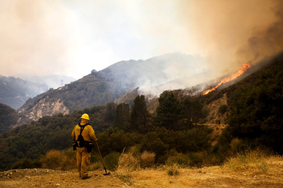 A firefighter watches the Station Fire as it burns in Angeles National Forest Sunday, Aug. 30, 2009 in La Canada Flintridge, Calif. (AP Photo/Philip Scott Andrews)