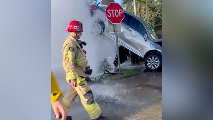 Crash in SoCal leaves car suspended by gushing water