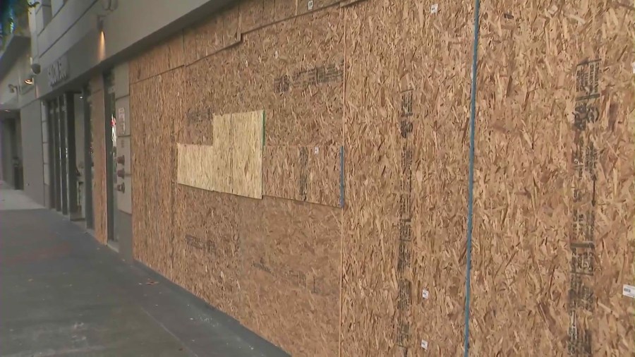 Shop windows were boarded up after a man went on a window-smashing spree in Long Beach's East Village neighborhood on June 6, 2024. (KTLA)