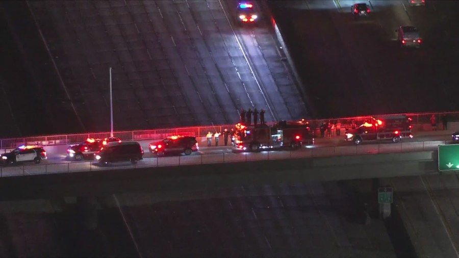 Civilians and law enforcement gathered on a freeway overpass to honor Andrew Pontious as a procession passed by underneath them on June 14, 2024. (KTLA)