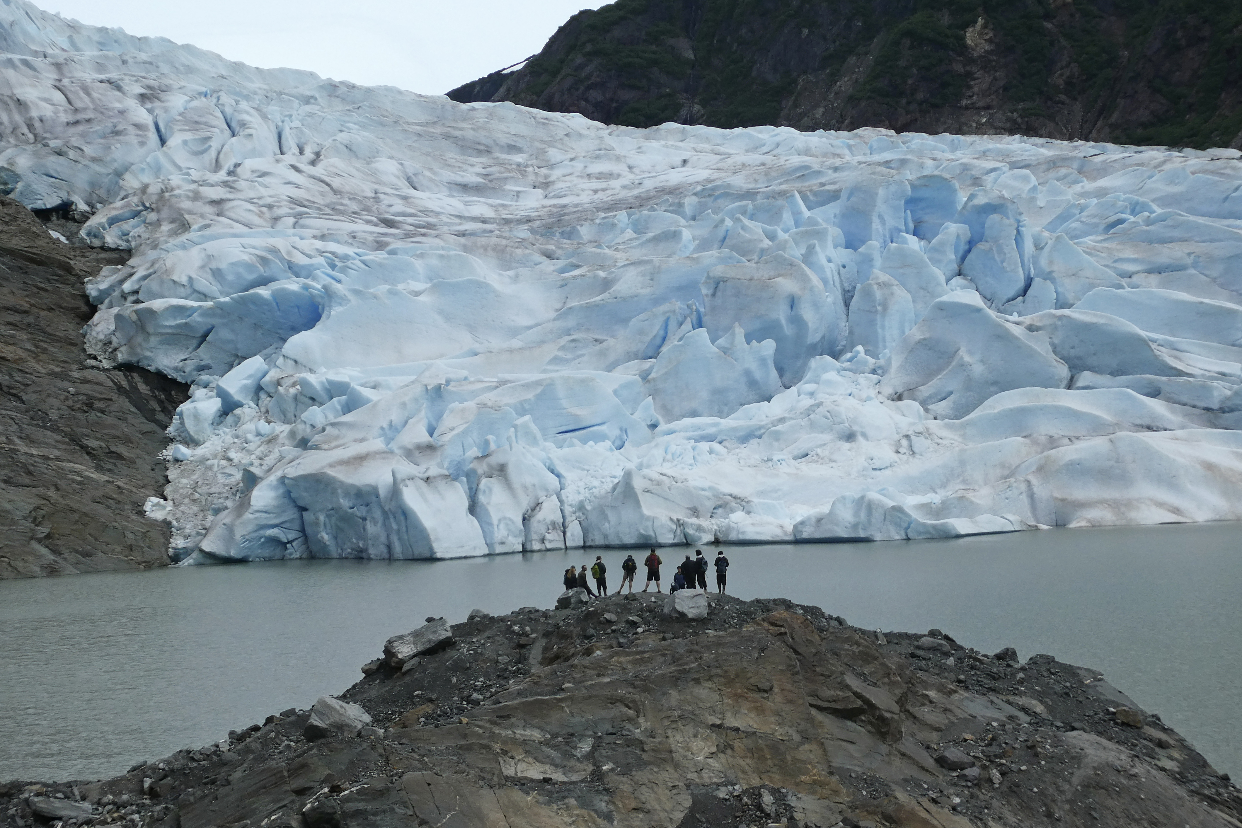 FILE - A group of people take in the views of the Mendenhall Glacier on June 8, 2023, in Juneau, Alaska. A new study says the melting of Alaska’s Juneau icefield, home to more than 1,000 glaciers, is accelerating. (AP Photo/Becky Bohrer, File)