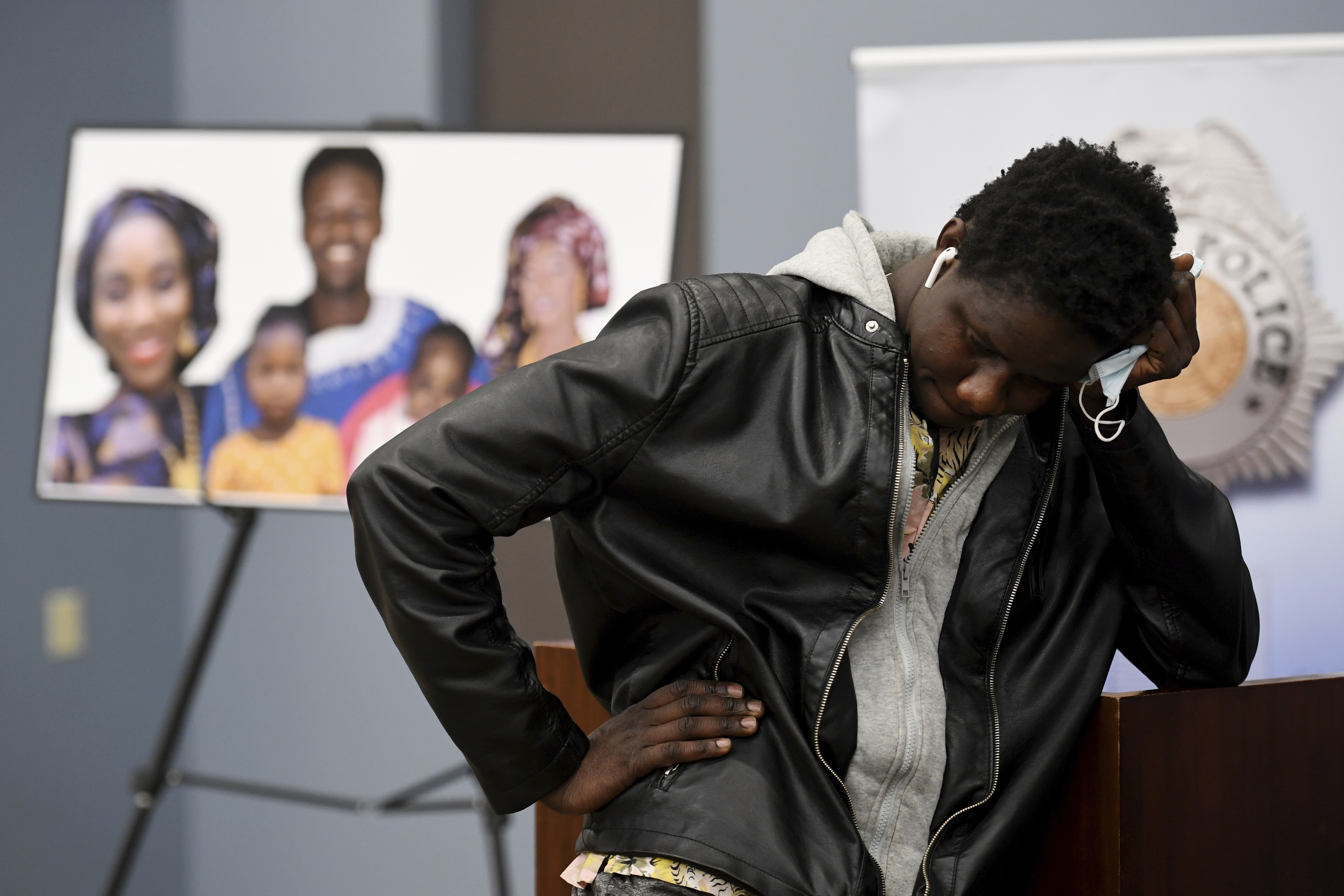FILE- Abou Diol holds his head next to a picture of his brother, Djibril Diol, after a Denver Police news conference Jan. 27, 2021, at Denver Police Crime Laboratory in Denver. Kevin Bui has been sentenced to 60 years in prison, Tuesday, July 2, 2024, after he pleaded guilty to murder charges for starting a 2020 house fire that killed five members Diol's family. (Hyoung Chang/The Denver Post via AP, File)