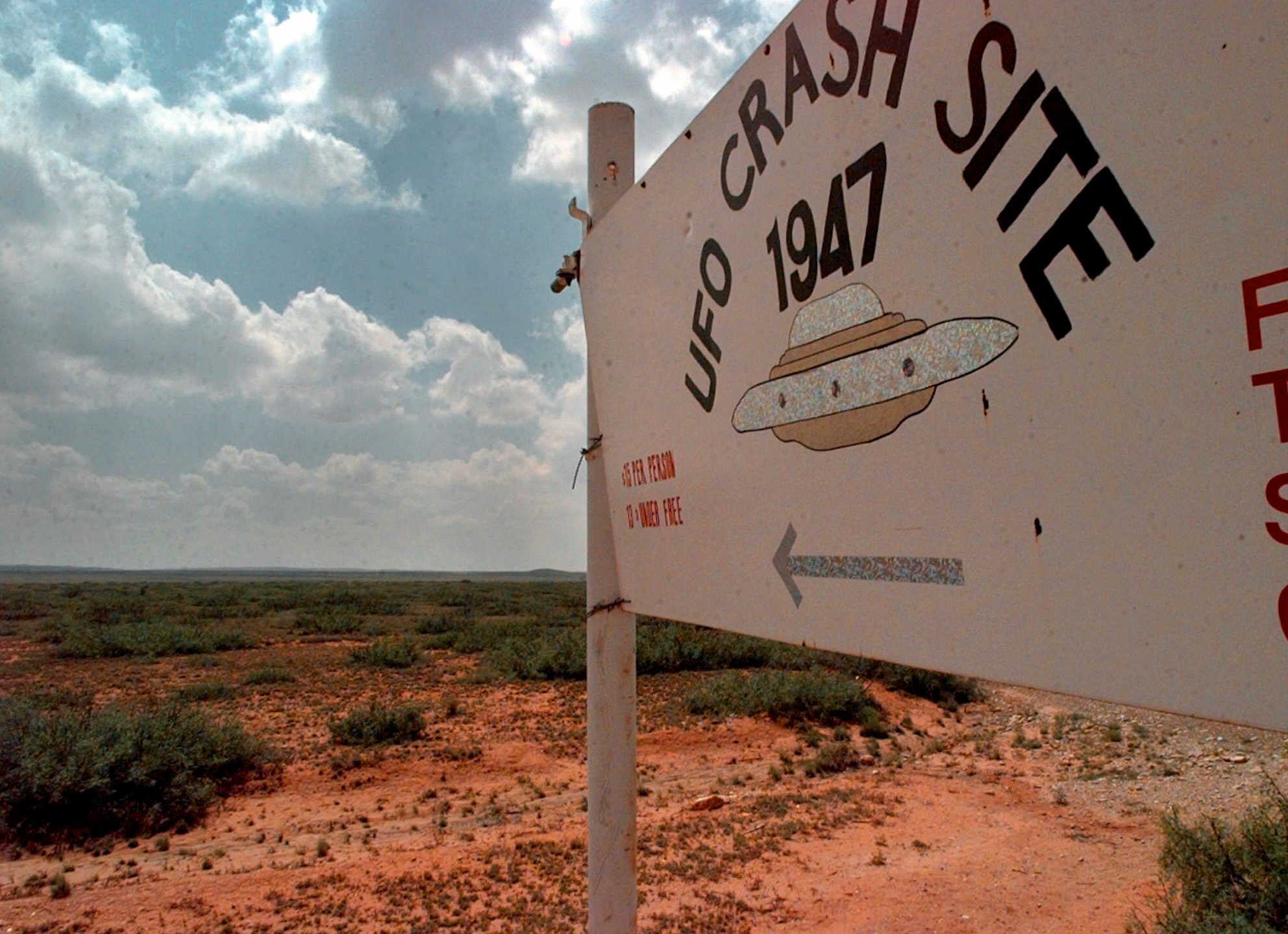 FILE - A sign directs travelers to the start of the "1947 UFO Crash Site Tours" in Roswell, N.M., June 10, 1997. World UFO Day is being celebrated amid a surge in sightings and government studies on unidentified flying objects. Its date of July 2nd has its roots in the so-called Roswell incident on July 2, 1947. (AP Photo/Eric Draper, File)