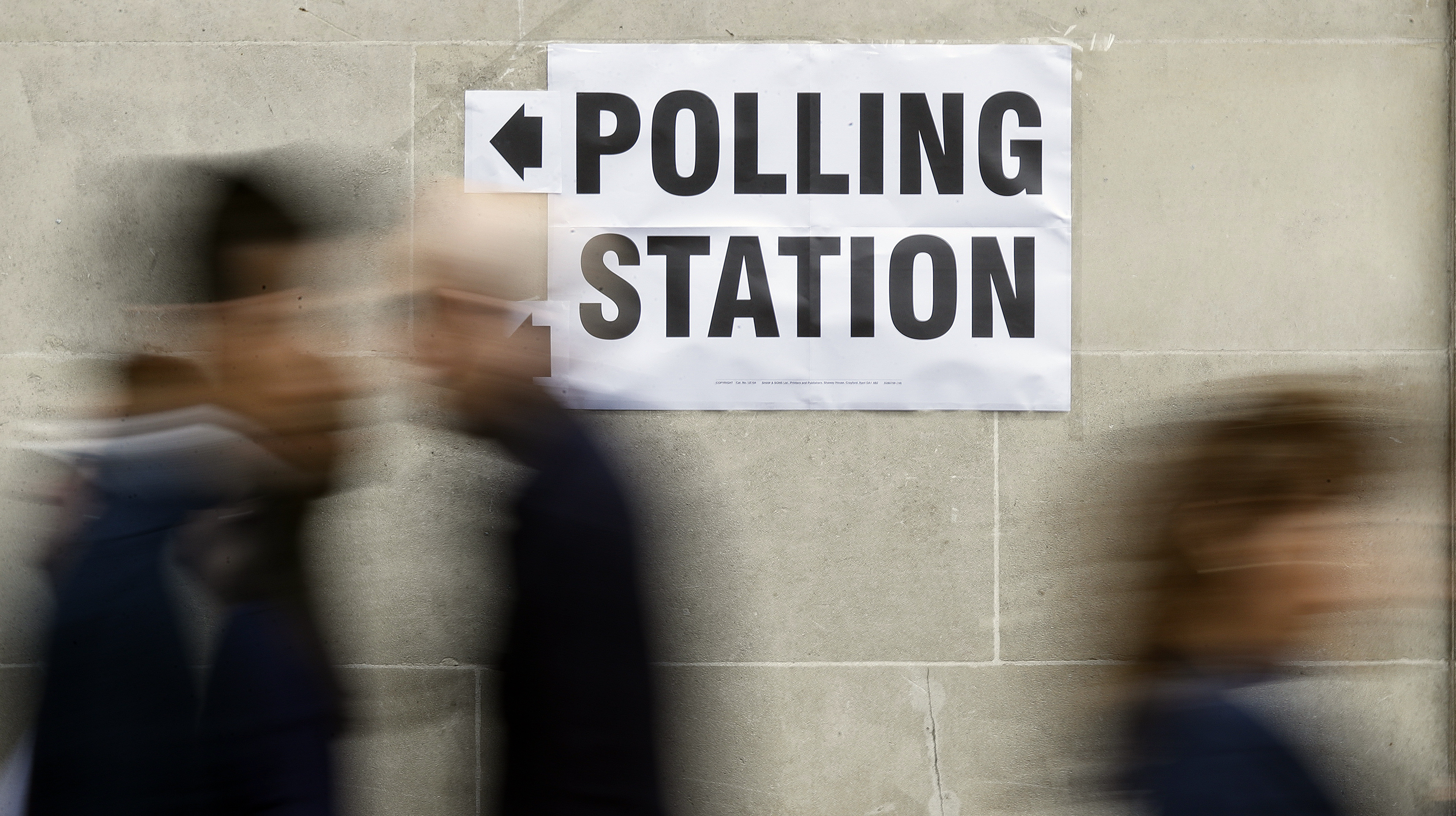 FILE - People walk to a polling station for the British general election in Westminster, London, Thursday, June 8, 2017. From red wall to king's speech, UK elections have a vocabulary all their own. (AP Photo/Frank Augstein, File)