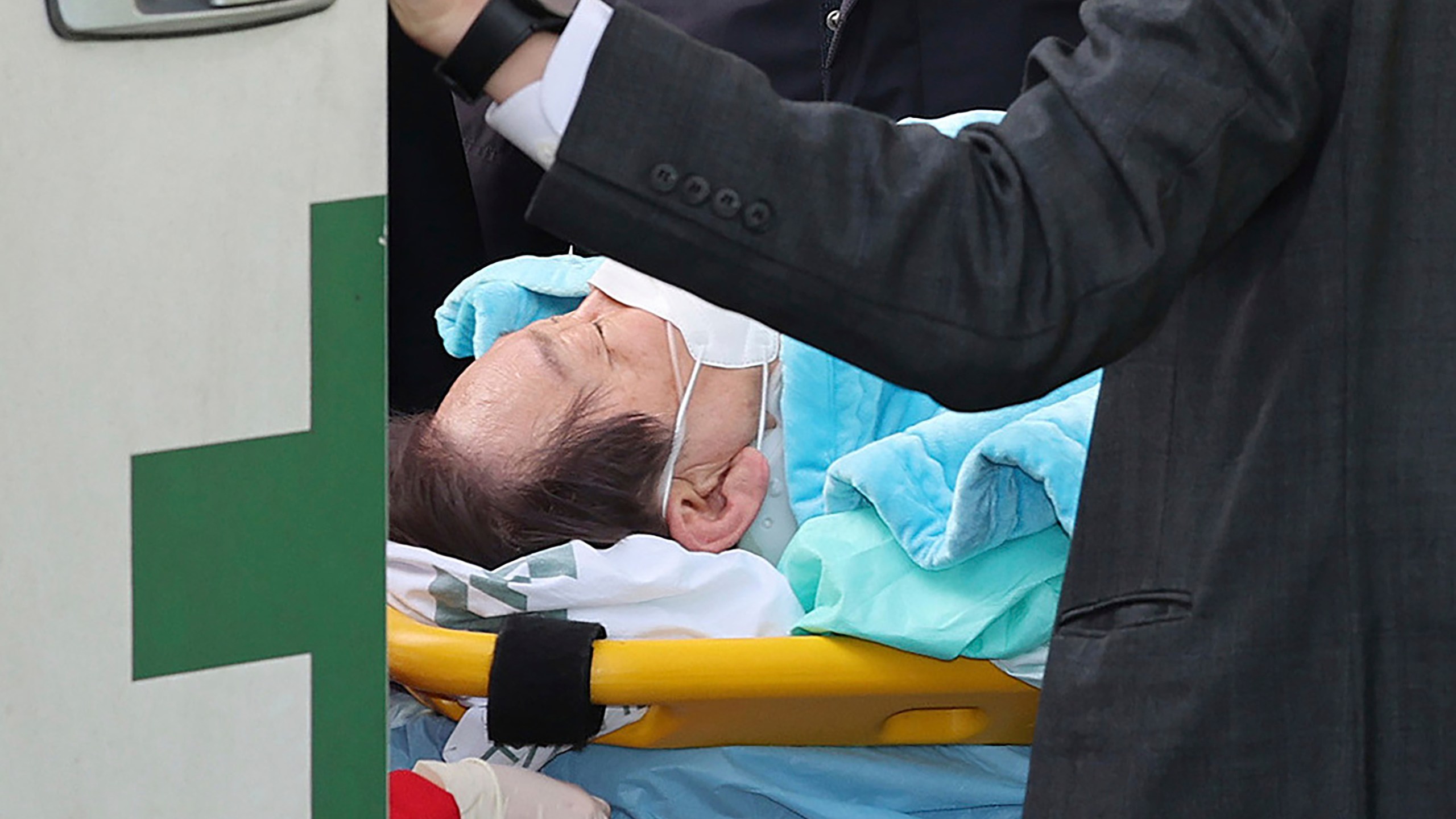 FILE - Then South Korea's main opposition Democratic Party leader Lee Jae-myung on a stretcher arrives at a heliport in Seoul, South Korea, on Jan. 2, 2024. A man who stabbed Lee in the neck earlier this year was sentenced to 15 years in prison on Friday, July 5, 2024, court officials said. (Im Hwa-young/Yonhap via AP, File)