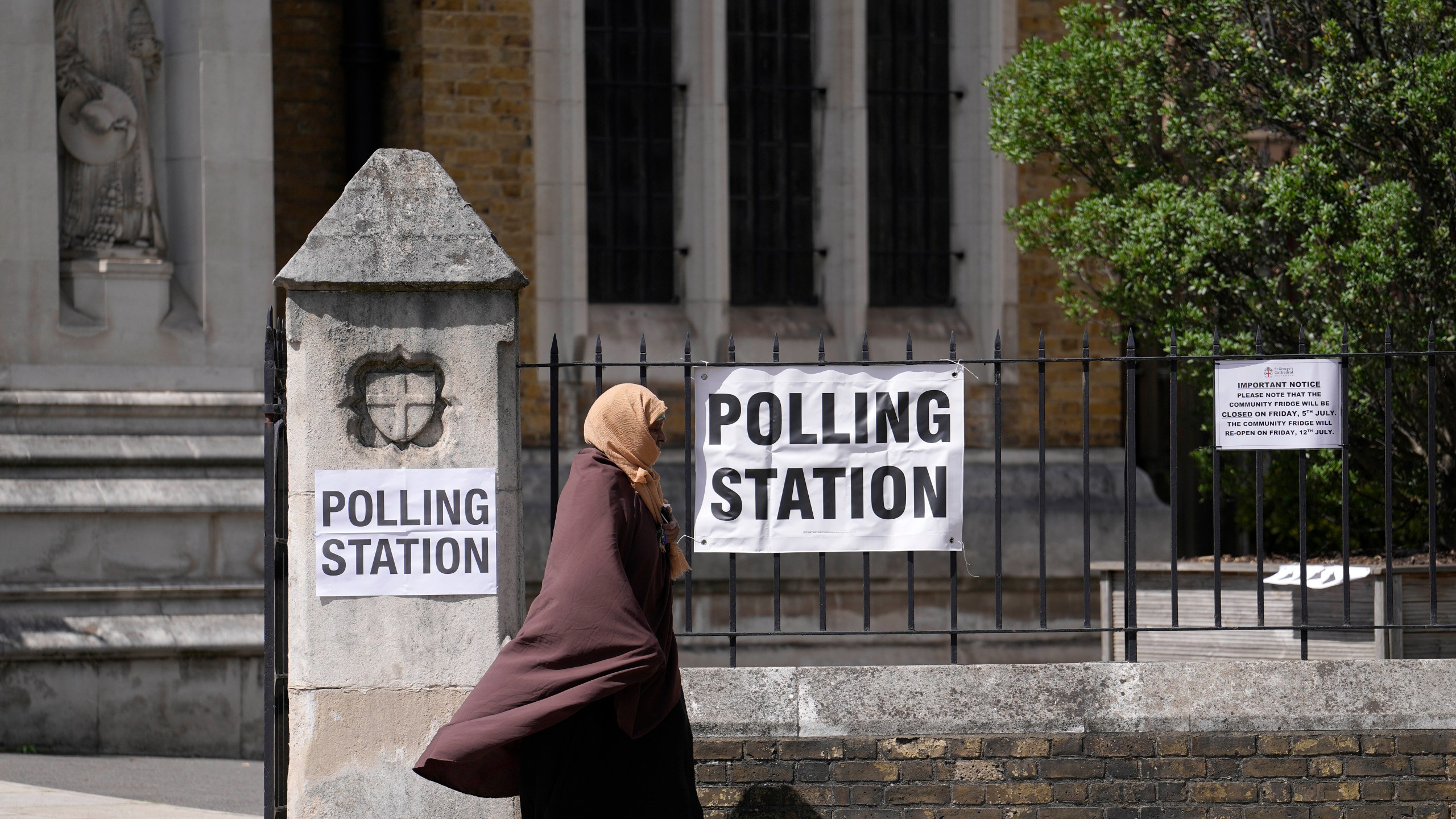 A woman leaves after casting her vote at a polling station in London, Thursday, July 4, 2024. Voters in the U.K. are casting their ballots in a national election to choose the 650 lawmakers who will sit in Parliament for the next five years. Outgoing Prime Minister Rishi Sunak surprised his own party on May 22 when he called the election. (AP Photo/Vadim Ghirda)
