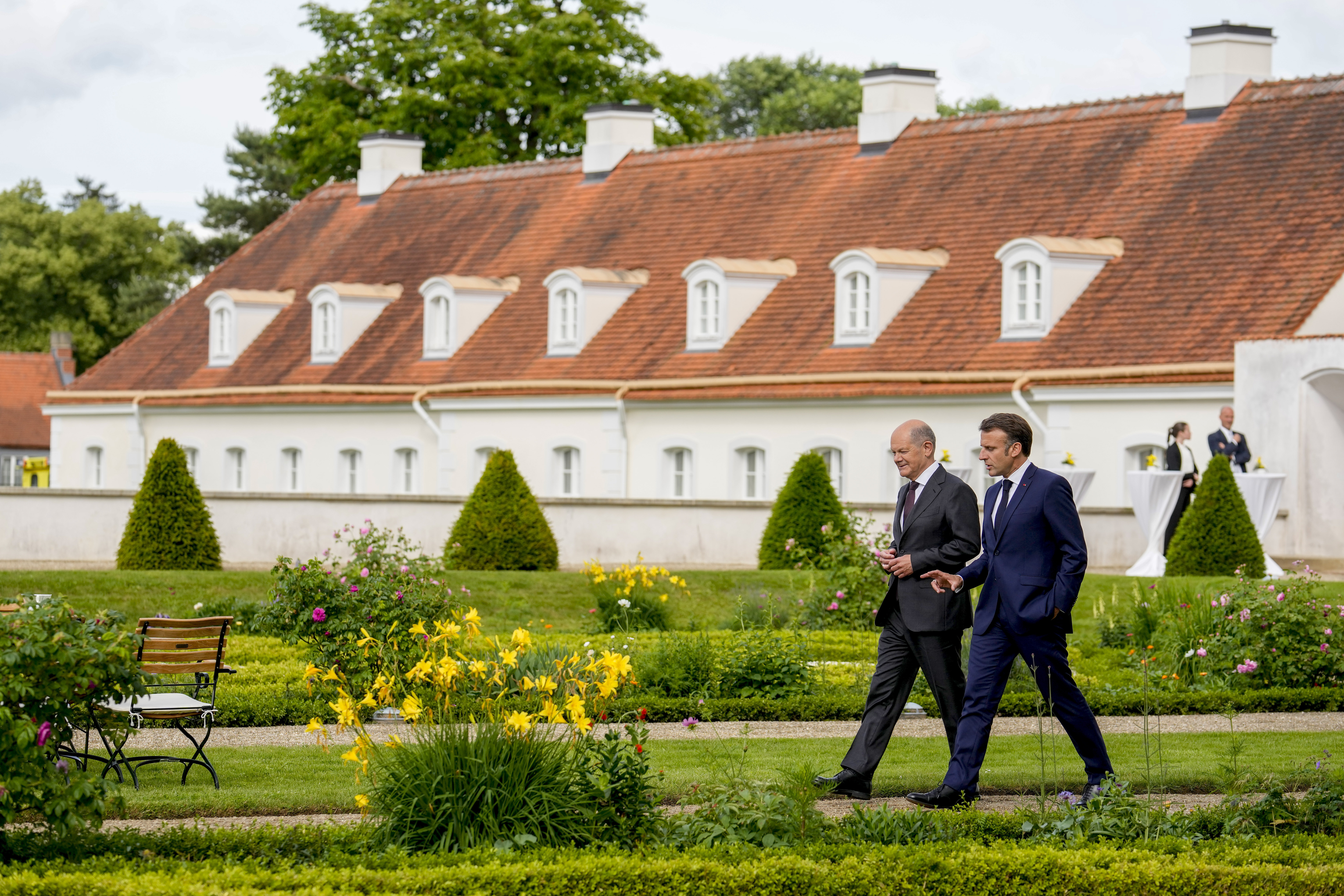 FILE - German Chancellor Olaf Scholz, left, and French President Emmanuel Macron walk through the garden of the German government guest house Meseberg Palace to the Franco-German Ministerial Council in Meseberg, north of Berlin, Germany, on May 28, 2024. The German government has expressed concern about a possible victory of the far-right National Rally in France. Chancellor Scholz and many ordinary Germans fears that if the the nationalist French party gets elected on Sunday, it would no longer support the close and unique relationship between the two countries that was carefully built over decades since the end of World War II. (AP Photo/Ebrahim Noroozi, Pool)