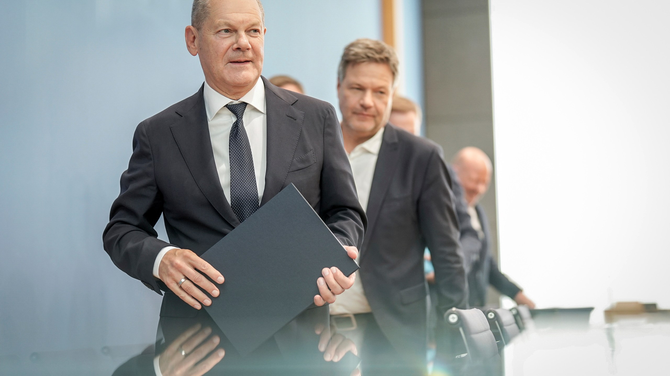 German Chancellor Olaf Scholz, left, followed by German Minister for Economic Affairs and Climate Protection Robert Habeck, leave following a press conference on the 2025 budget, in Berlin, Friday, July 5, 2024. The coalition parties have agreed on a draft budget. (Kay Nietfeld/dpa via AP)