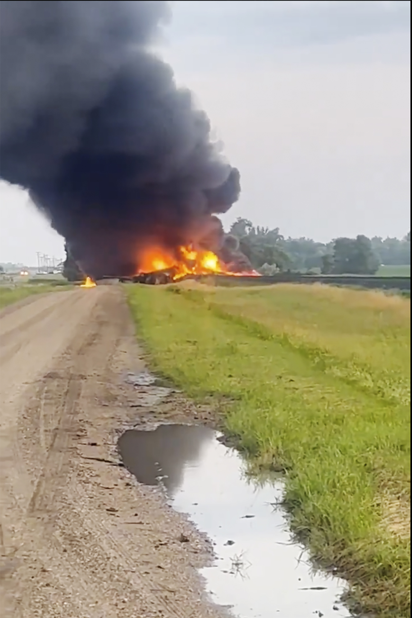 This photo provided by Doug Zink, smoke fills the sky after a train derailment on Friday, July 5, 2024 near Carrington, N.D. Rail cars containing hazardous material derailed and burst into flames early Friday in a remote area of North Dakota, but emergency officials say no one was hurt and the threat to those living nearby appears to be minimal. (Doug Zink via AP)