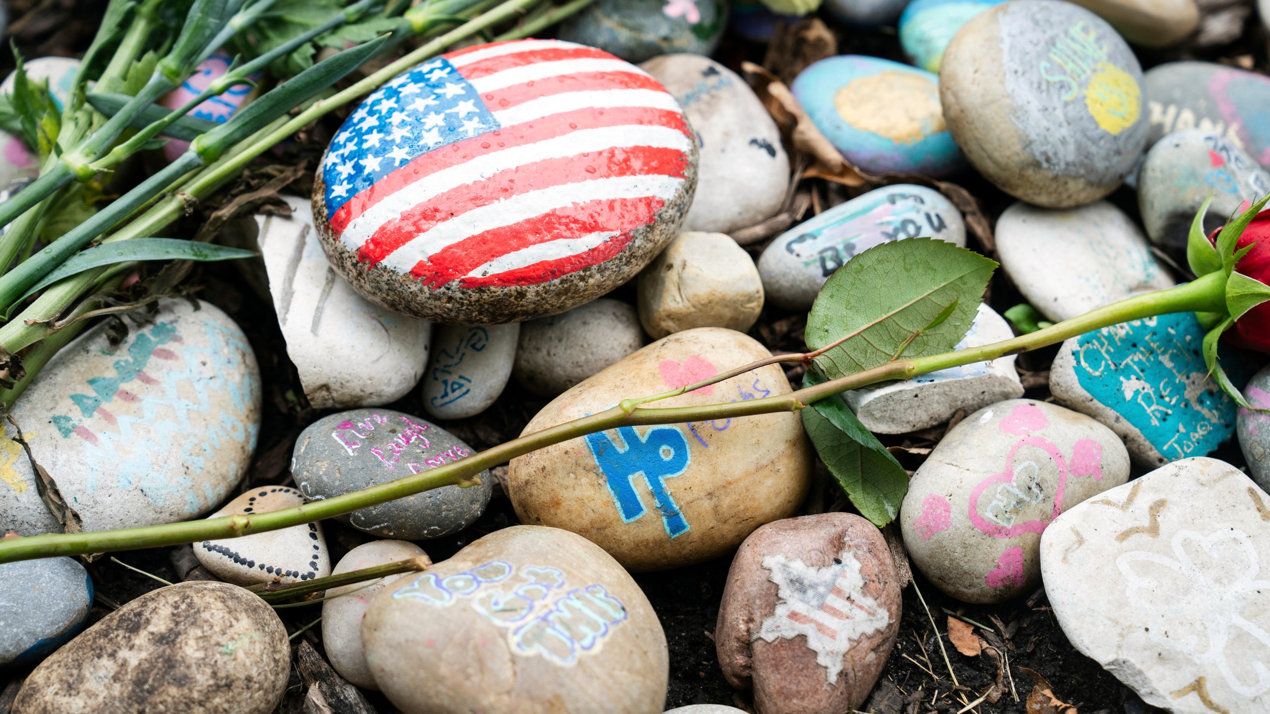 The temporary memorial for the Highland Park shooting victims, Katie Goldstein, Irina McCarthy, Kevin Michael McCarthy, Stephen Straus, Jacki Lovi Sundheim, Nicolás Toledo and Eduardo Uvaldo, is seen near 1707 St. Johns Avenue in Highland Park, Ill., Thursday, July 4, 2024, two years after a mass shooting at the parade. (Pat Nabong/Chicago Sun-Times via AP)