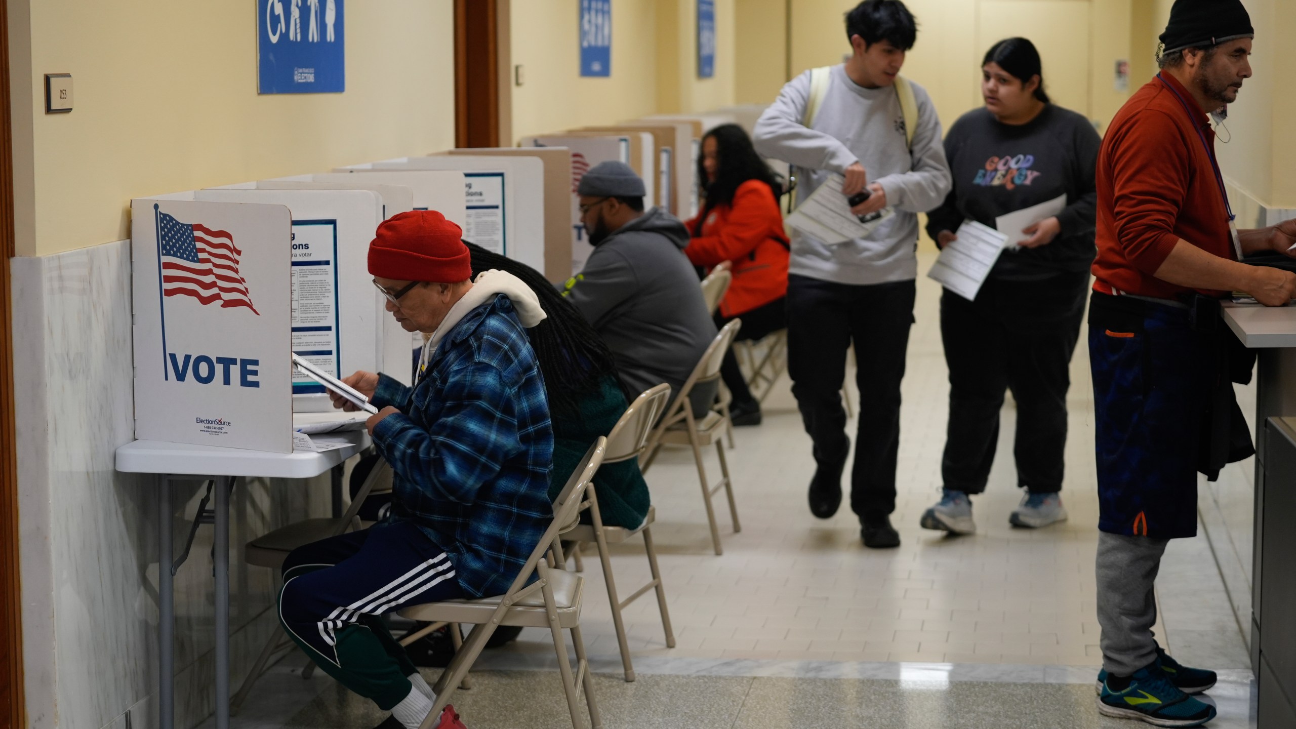 FILE - People vote and turn in their ballots at City Hall in San Francisco, Tuesday, March 5, 2024. Slavery, same-sex marriage and shoplifting are among the 10 statewide ballot measures California voters will consider in November. (AP Photo/Eric Risberg,File)