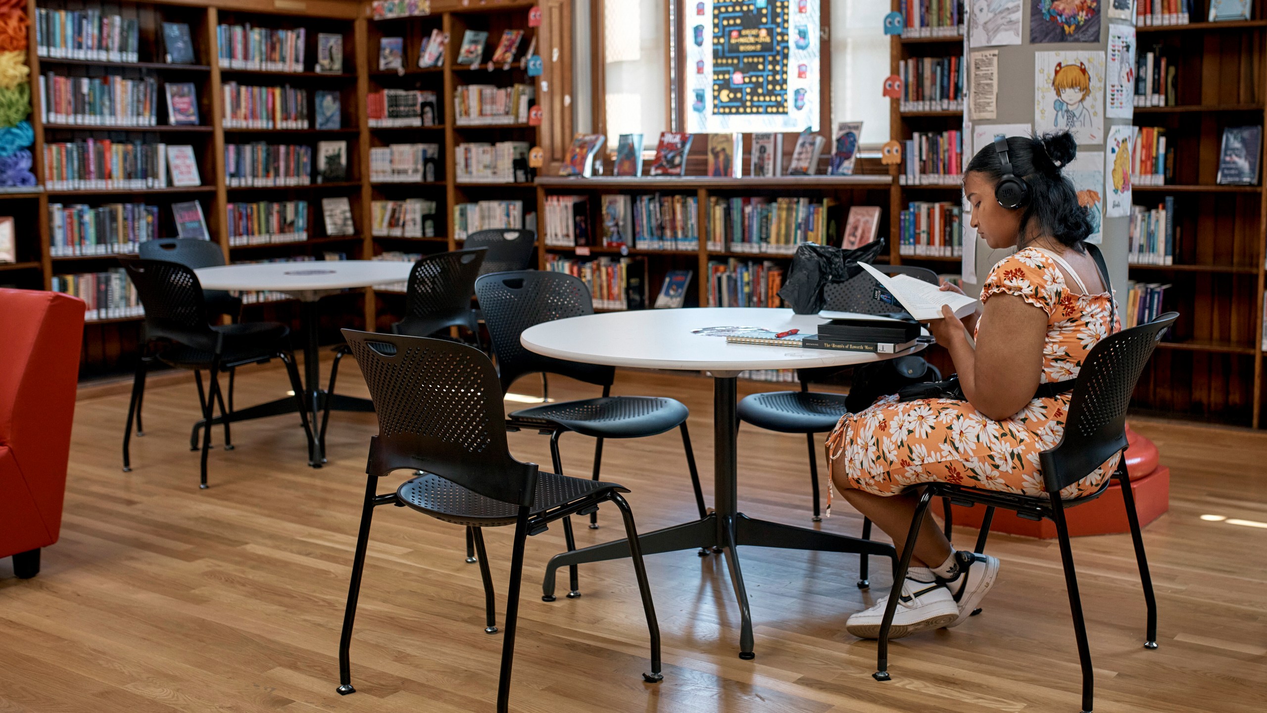 -A woman spends time at a library during a hot day, Friday, June 21, 2024, in the Bronx Borough of New York. Tens of millions of Americans are facing major heat waves, with temperatures consistently exceeding 90 degrees (32 degrees Celsius).(AP Photo/Andres Kudacki)