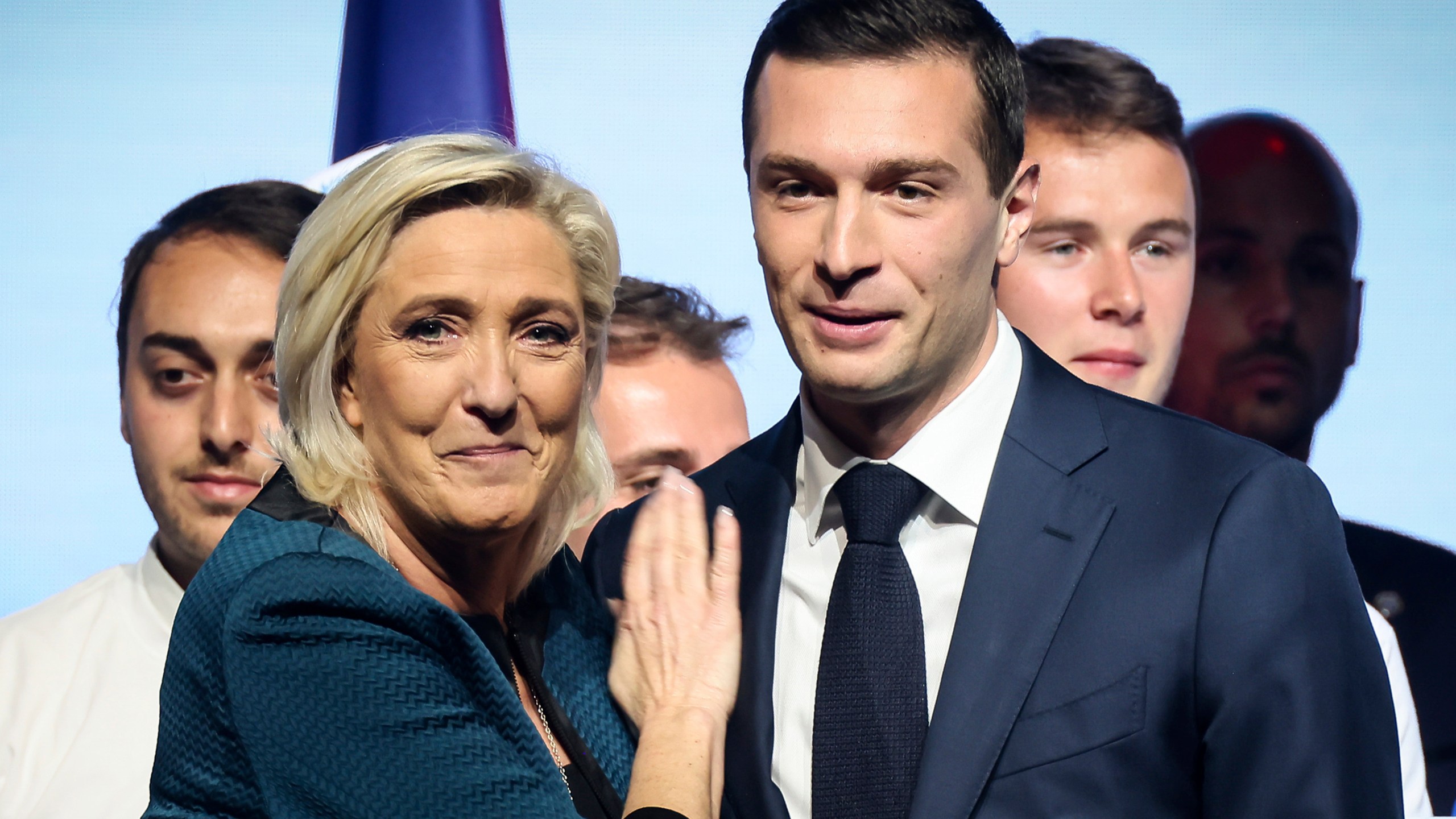 FILE - Leader of the French far-right National Rally Marine Le Pen, left, and lead candidate of the party for the upcoming European election Jordan Bardella during a political meeting on June 2, 2024 in Paris. Jordan Bardella, Le Pen's 28-year-old protégé who she'd been hoping to install as prime minister, grumbled that "the alliance of dishonor" between the National Rally's rivals kept it from power. (AP Photo/Thomas Padilla, File)