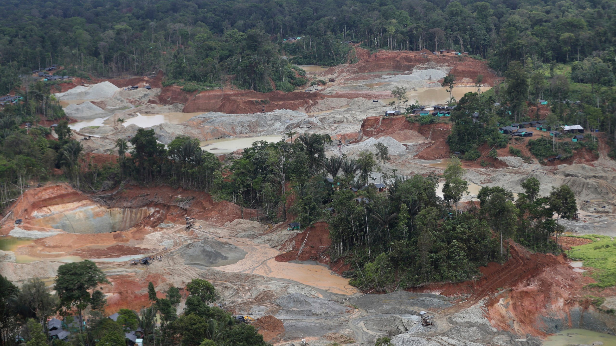 FILE - An illegal gold mining operation that contributed to deforestation is visible in Magui Payan, Colombia, April 20, 2021. The mine was among targets for destruction by National Police and soldiers in a crackdown against mining. Deforestation in Colombia fell 36% in 2023 versus the previous year, the government said in a press conference on Monday, July 8, 2024, marking the lowest level since records began. (AP Photo/Fernando Vergara, File)