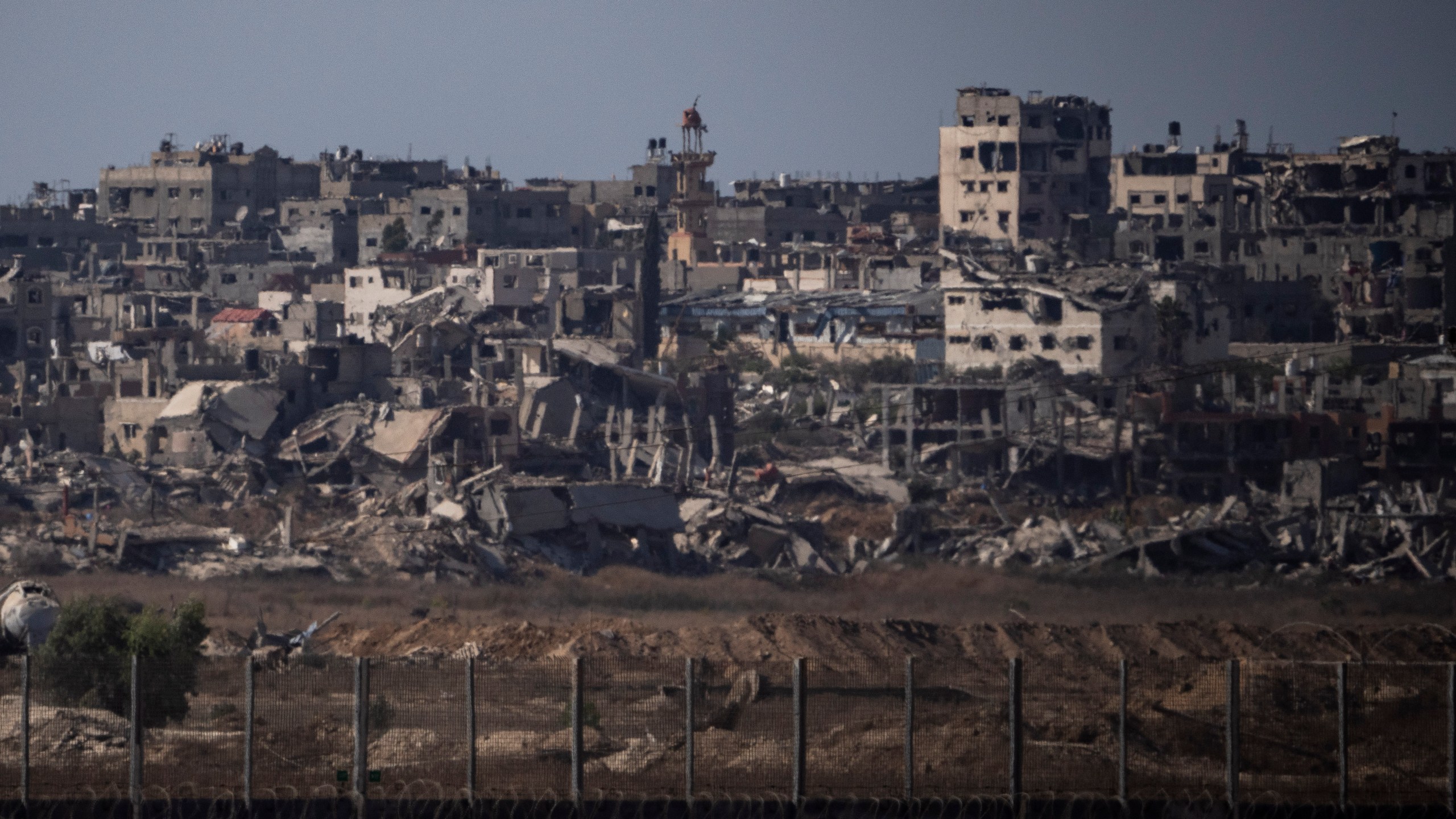 Destroyed buildings stand in the Gaza Strip, as seen from southern Israel, Monday, July 8, 2024. Israeli forces advanced deeper into the Gaza Strip's largest city in pursuit of militants who had regrouped there, sending thousands of Palestinians fleeing on Monday from an area ravaged in the early weeks of the nine-month-long war. (AP Photo/Leo Correa)