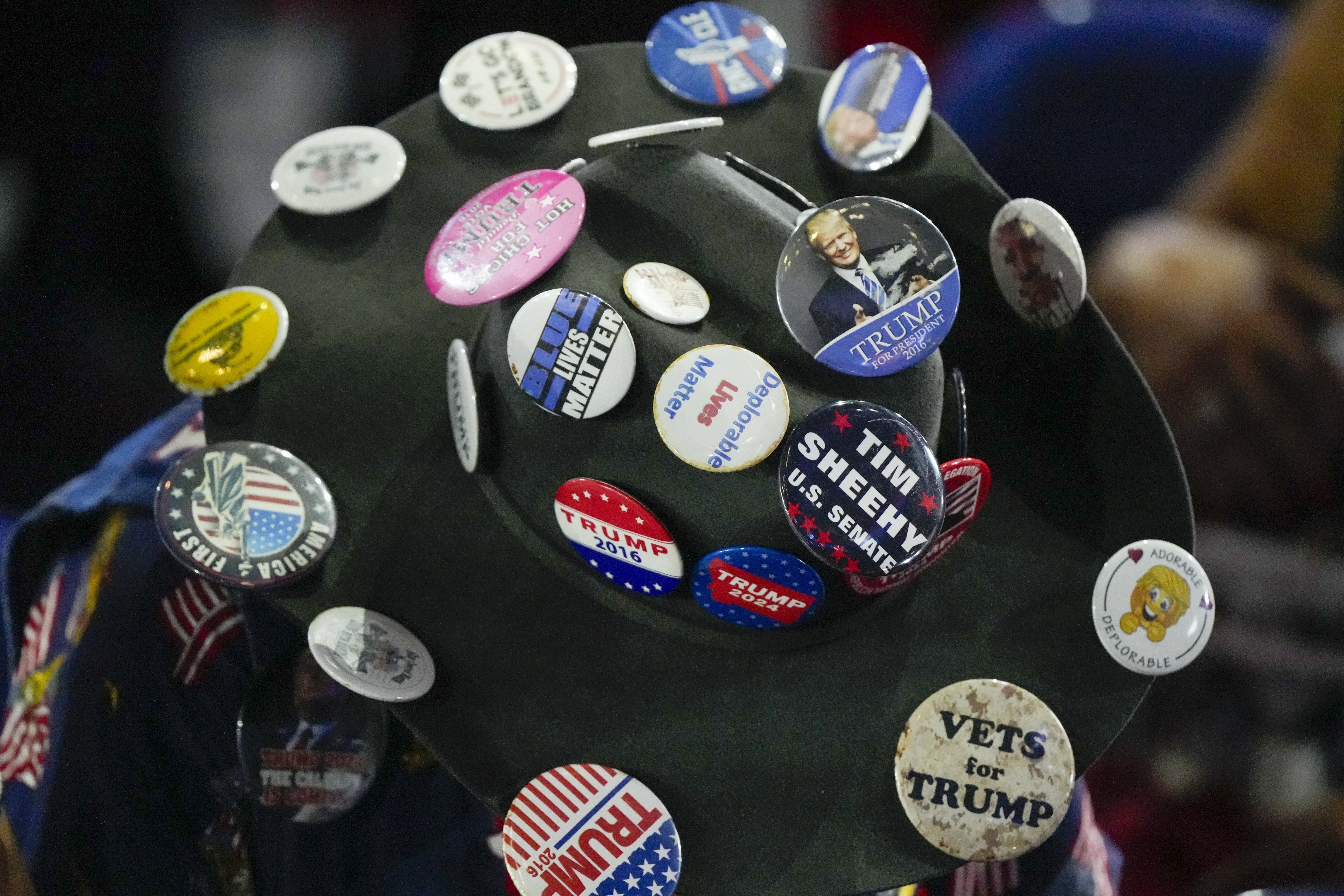 A delegate wears a pin filled hat during the Republican National Convention Monday, July 15, 2024, in Milwaukee. (AP Photo/Matt Rourke)