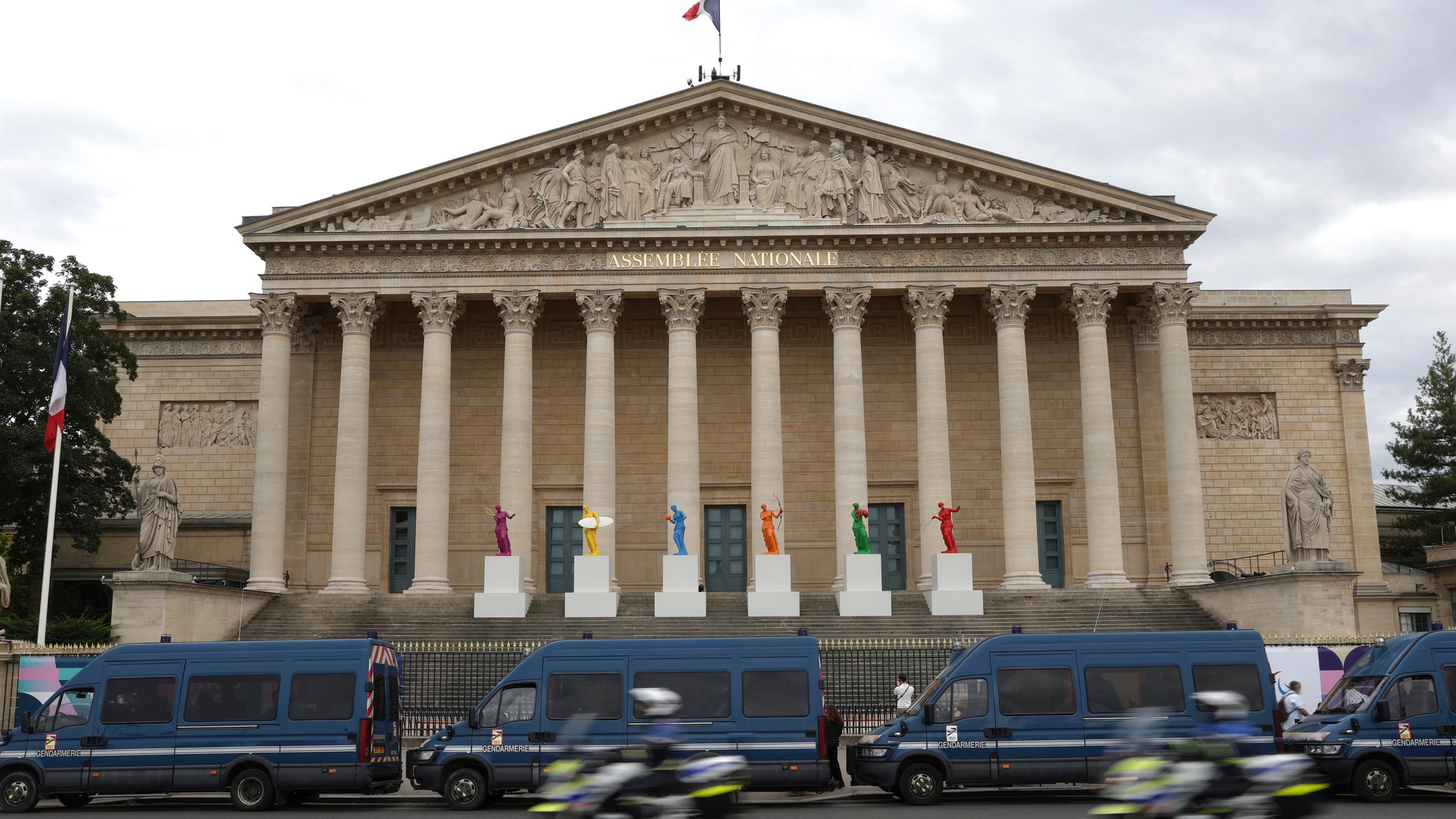 FILE - Police vans park outside the National Assembly during the second round of the legislative elections in Paris, Sunday, July 7, 2024. France’s far right leader Marine Le Pen says the country is “in a quagmire” after the chaotic legislative elections have produced a fragmented parliament and a deeply divided society as Paris prepares to host the Olympic Games at the end of the month. (AP Photo/Aurelien Morissard, File)