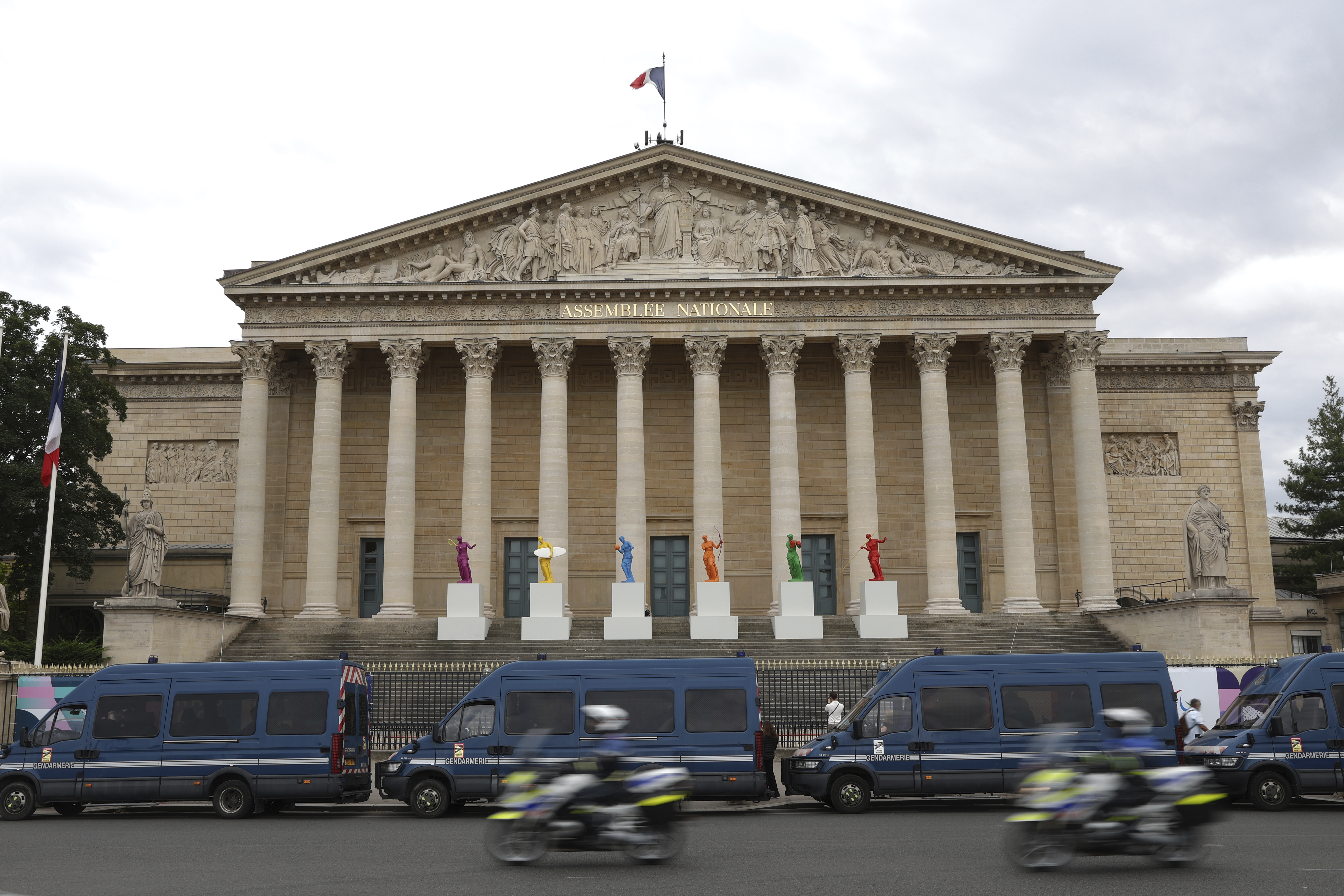 FILE - Police vans park outside the National Assembly during the second round of the legislative elections in Paris, Sunday, July 7, 2024. France’s far right leader Marine Le Pen says the country is “in a quagmire” after the chaotic legislative elections have produced a fragmented parliament and a deeply divided society as Paris prepares to host the Olympic Games at the end of the month. (AP Photo/Aurelien Morissard, File)