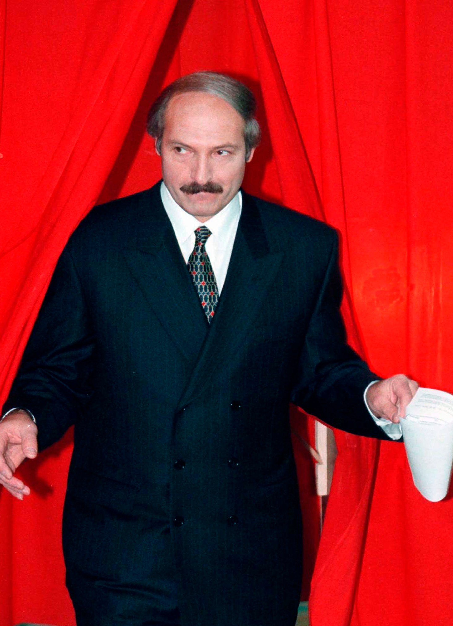 FILE - President Alexander Lukashenko of Belarus emerges from a polling booth after voting in a national referendum in Minsk, Belarus, on Nov. 24, 1996. Lukashenko, who marks 30 years in power on Saturday, is one of the world's longest-serving and most ruthless leaders. (AP Photo, File)