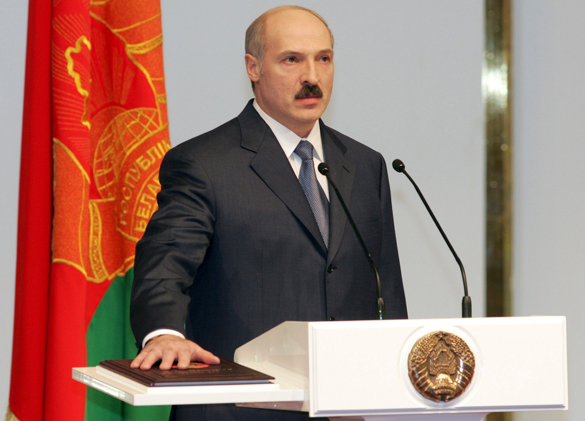 FILE - Belarusian President Alexander Lukashenko takes the oath of office for a third term by placing his hand on the country’s constitution during his inauguration at the Palace of the Republic in Minsk, Belarus, on April 8, 2006. The authoritarian leader this week marks 30 years in power as president. (Nikolai Petrov, BelTA via AP, File)