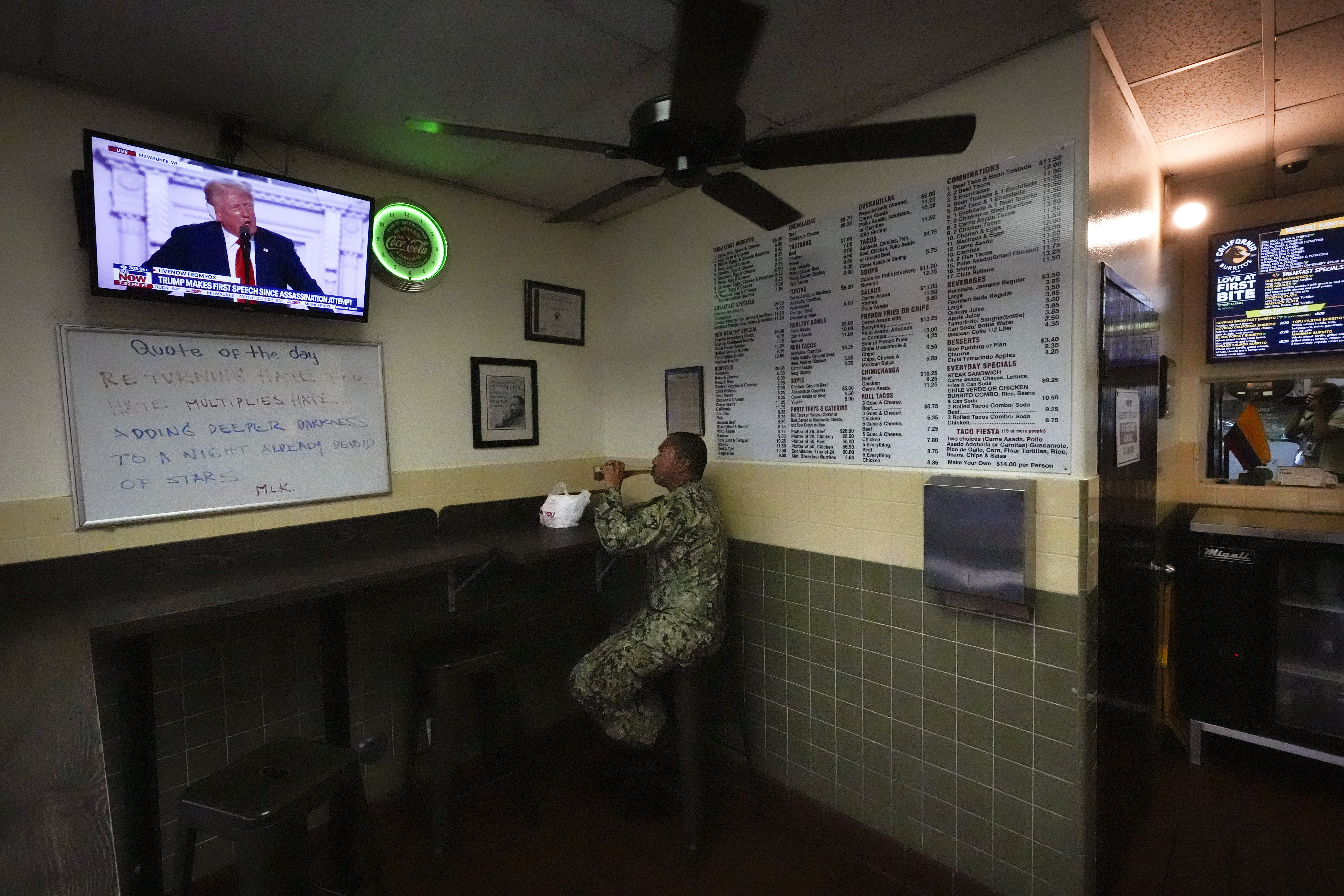 A man watches as Republican presidential candidate former President Donald Trump addresses the Republican National Convention on television at California Burritos restaurant, Thursday, July 18, 2024, in San Diego. (AP Photo/Gregory Bull)