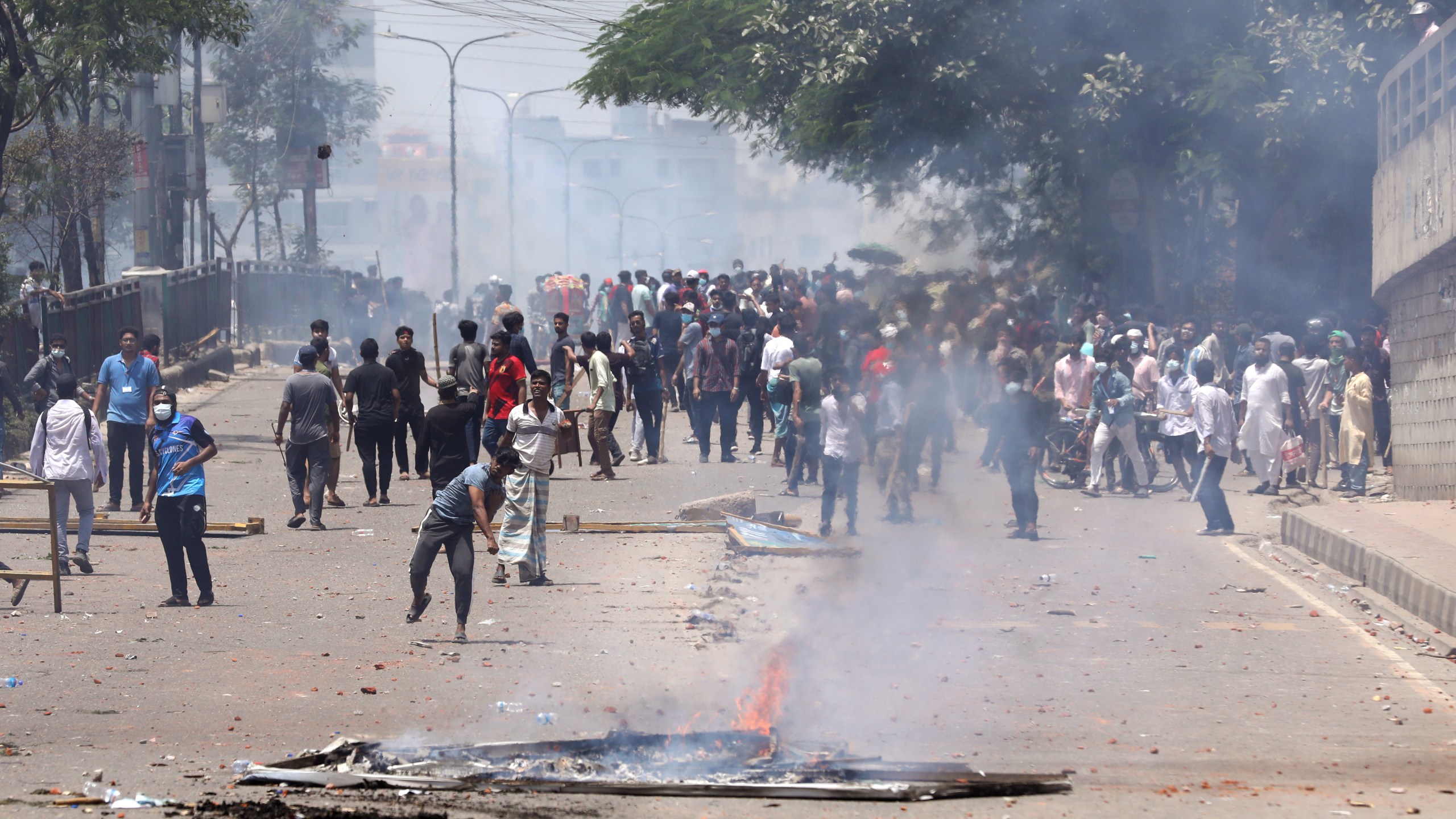 Students clash with riot police during a protest against a quota system for government jobs, in Dhaka, Bangladesh, Thursday, July 18, 2024. (AP Photo/Rajib Dhar)