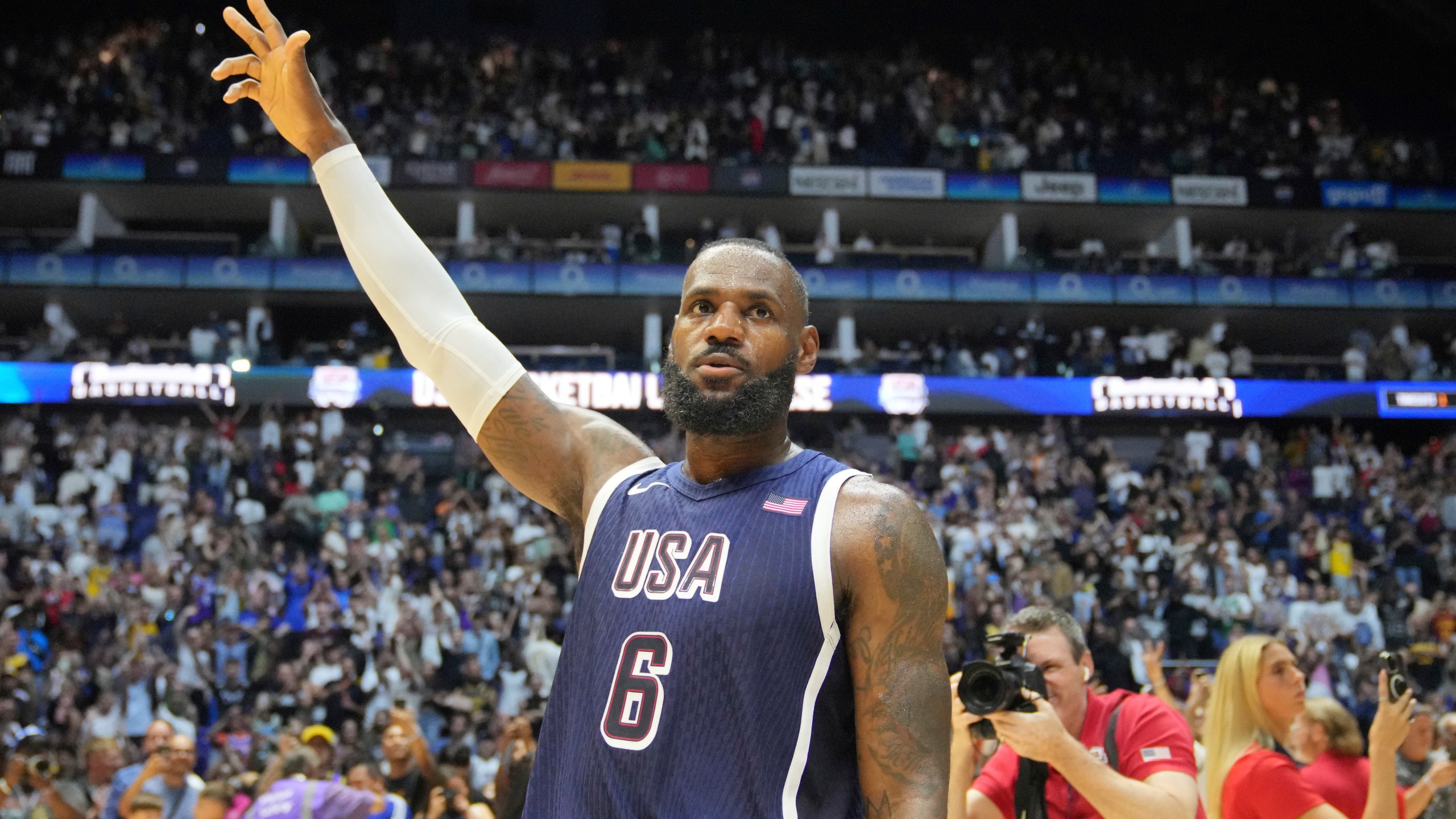 United States' forward LeBron James waves to the crowd after the end of an exhibition basketball game between the United States and South Sudan, at the o2 Arena in London, Saturday, July 20, 2024. (AP Photo/Kin Cheung)