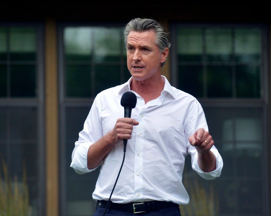 California Governor Gavin Newsom speaks with supporters during a stop Thursday, July 4, 2024, at the Van Buren County Democratic Party Fourth of July reception in South Haven, Mich.  Newsom offered a forceful defense of embattled President Joe Biden on Thursday, telling Democrats in Michigan that the 81-year-old president has the record and energy to win a second term despite widespread doubts about his ability to campaign or govern effectively. (Don Campbell/The Herald-Palladium via AP)