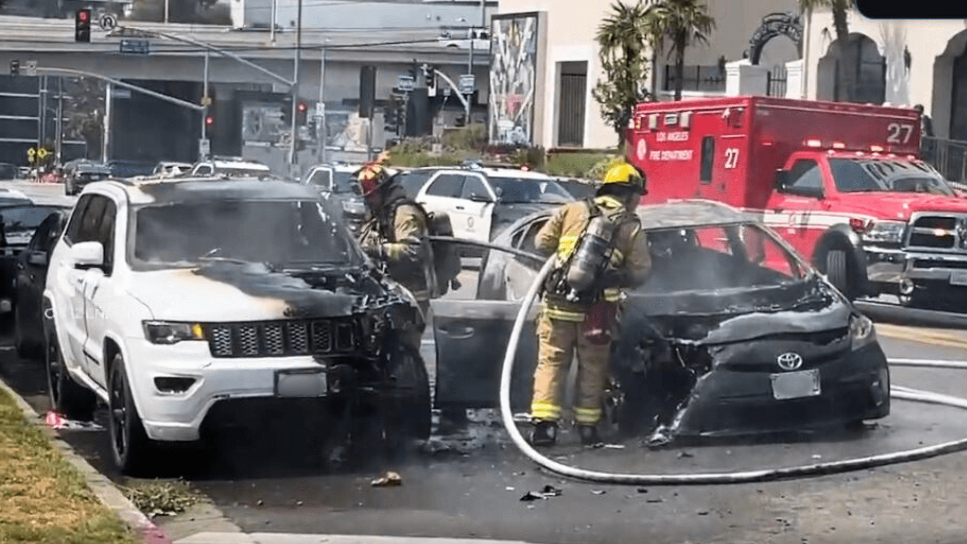 Firefighters extinguished two burning vehicles that were set ablaze by a woman in the Hollywood Hills on July 13, 2024. (Citizen)