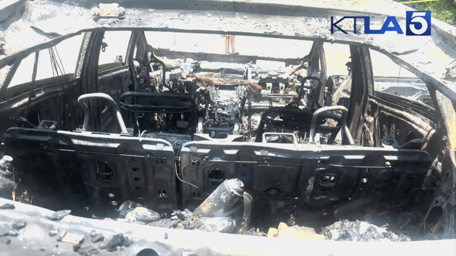 The charred remains of a vehicle that was set on fire by a suspect in the Hollywood Hills on July 13, 2024. (KTLA)